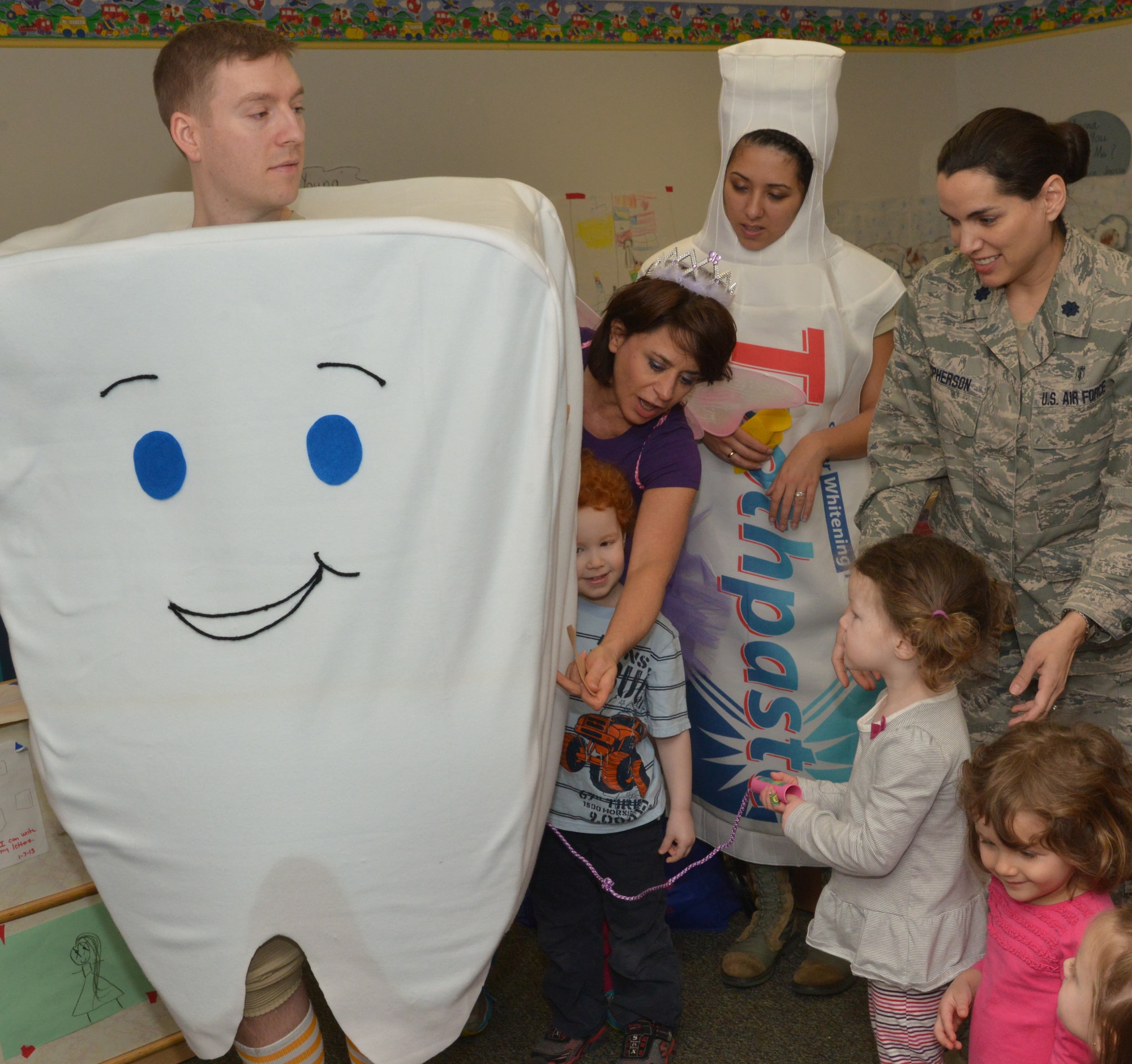 Students practice flossing with Timmy the Tooth played by Senior Airman Philip Madison, February 10, 2015. (U.S. Air Force photo by Ray Crayton)