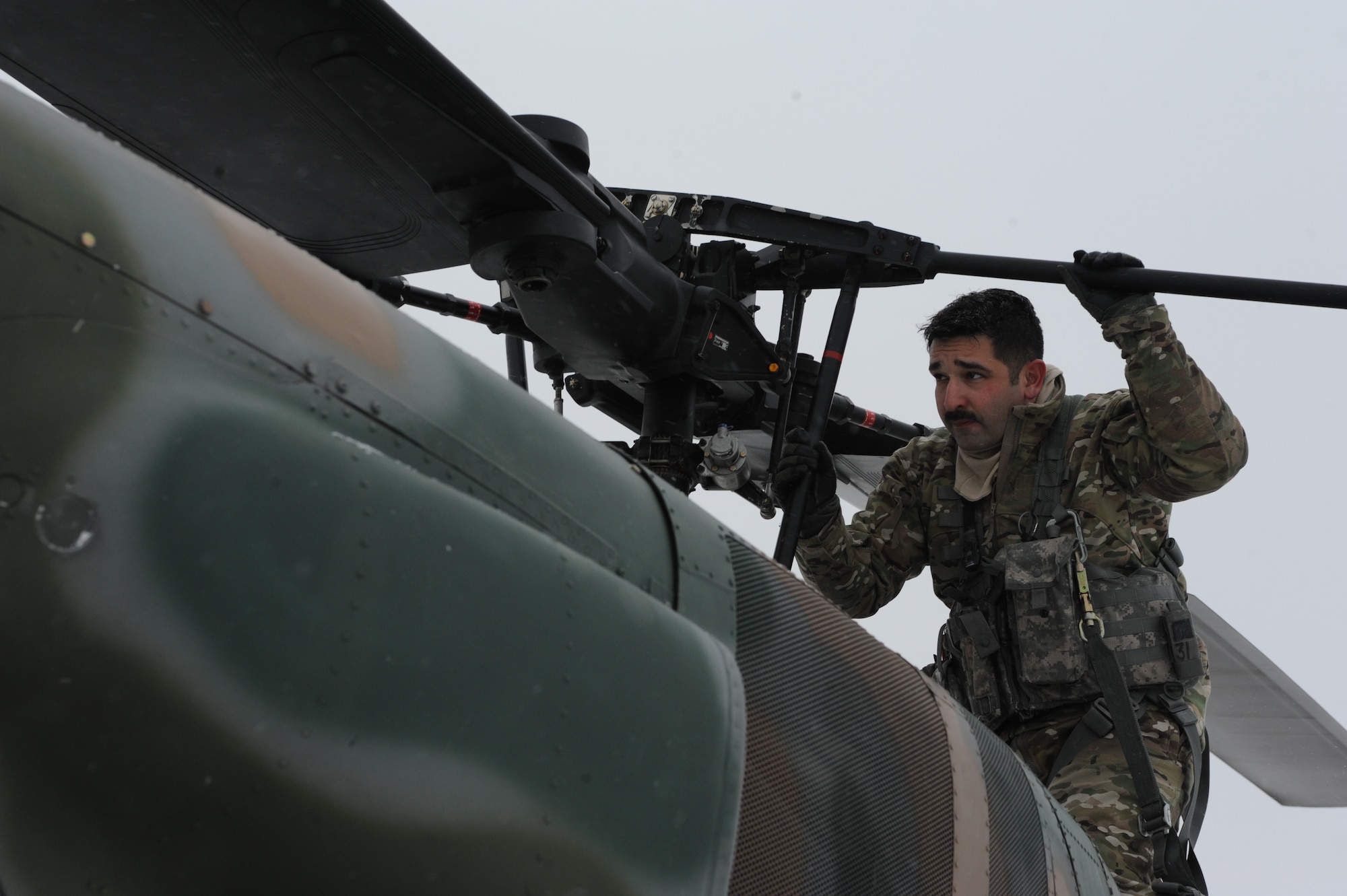 Tech. Sgt. Thomas Liscomb, 54th Helicopter Squadron flight engineer, conducts preflight checks on a UH1-N helicopter on Minot Air Force Base, N.D., Feb. 11, 2015. During checks, Liscomb ensures that everything from the propellers to the engines were flight-ready. (U.S. Air Force photos/Senior Airman Stephanie Morris)