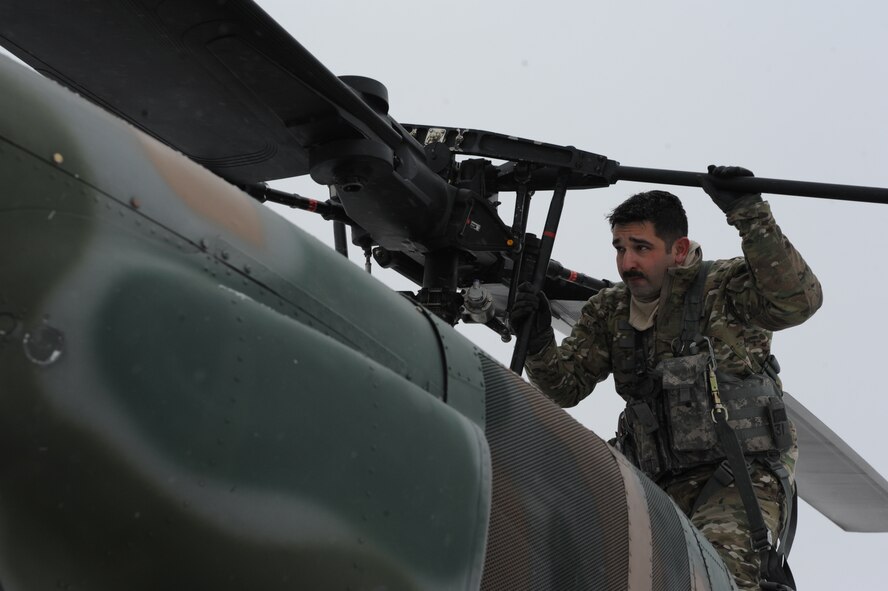 Tech. Sgt. Thomas Liscomb, 54th Helicopter Squadron flight engineer, conducts preflight checks on a UH1-N helicopter on Minot Air Force Base, N.D., Feb. 11, 2015. During checks, Liscomb ensures that everything from the propellers to the engines were flight-ready. (U.S. Air Force photos/Senior Airman Stephanie Morris)
