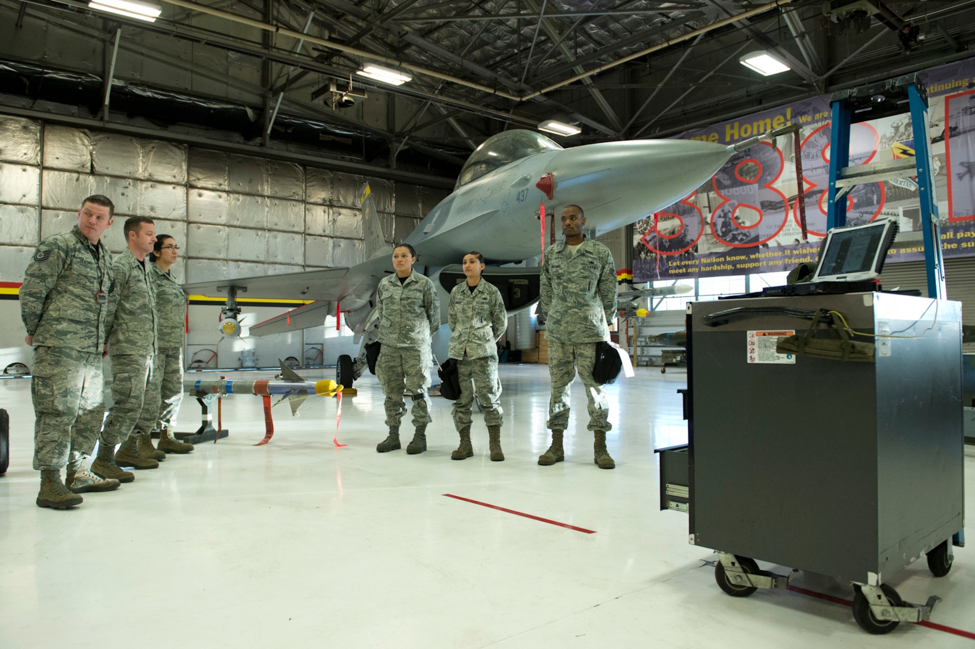 A 421st Aircraft Maintenance Unit crew stands before maintenance evaluators at the weapons load competition in Hangar 37 here Feb. 13, 2015. Two 421st AMU teams and one 466th AMU team raced to see which crew will be named, "Weapons Load Crew of the Year." Winners will be announced at the Maintenance Group annual awards banquet April 11, 2015. (U.S. Air Force photo/Ronald Bradshaw)
