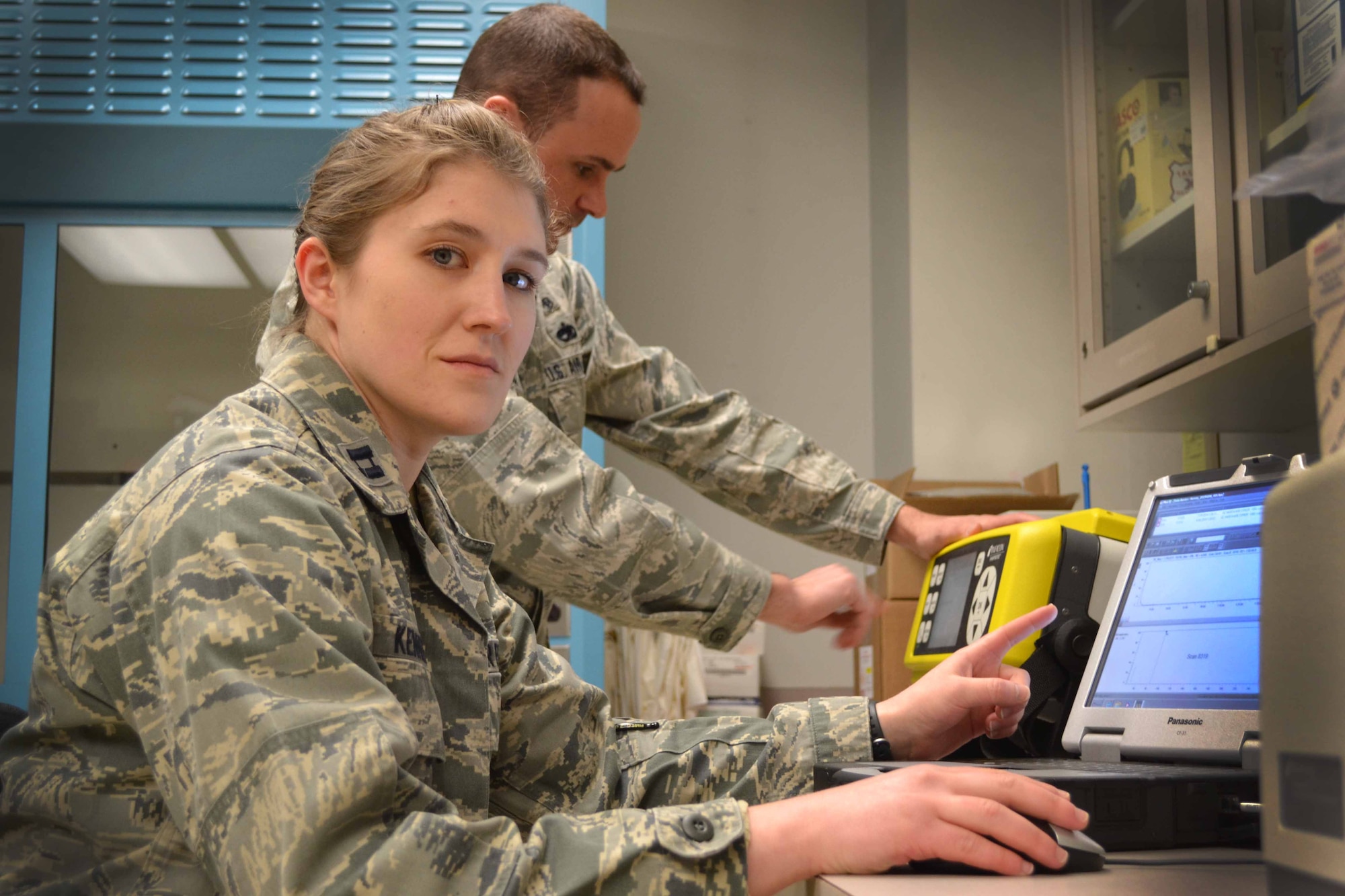 Capt. Jessica Kenney, 111th Attack Wing bioenvironmental engineer, conducts operations at her workstation with the assistance of Tech. Sgt. Joseph Runewicz, 111th ATKW, Feb. 12, 2015, Horsham Air Guard Station, Pa.  Bioenviornmental engineering technicians focus on supporting all aspects of the wing's mission such as: flight operations, maintenance, aerial port, logistics, vehicle maintenance, civil engineering and services. (U.S. Air National Guard Photo by Master Sgt. Christopher Botzum/Released)