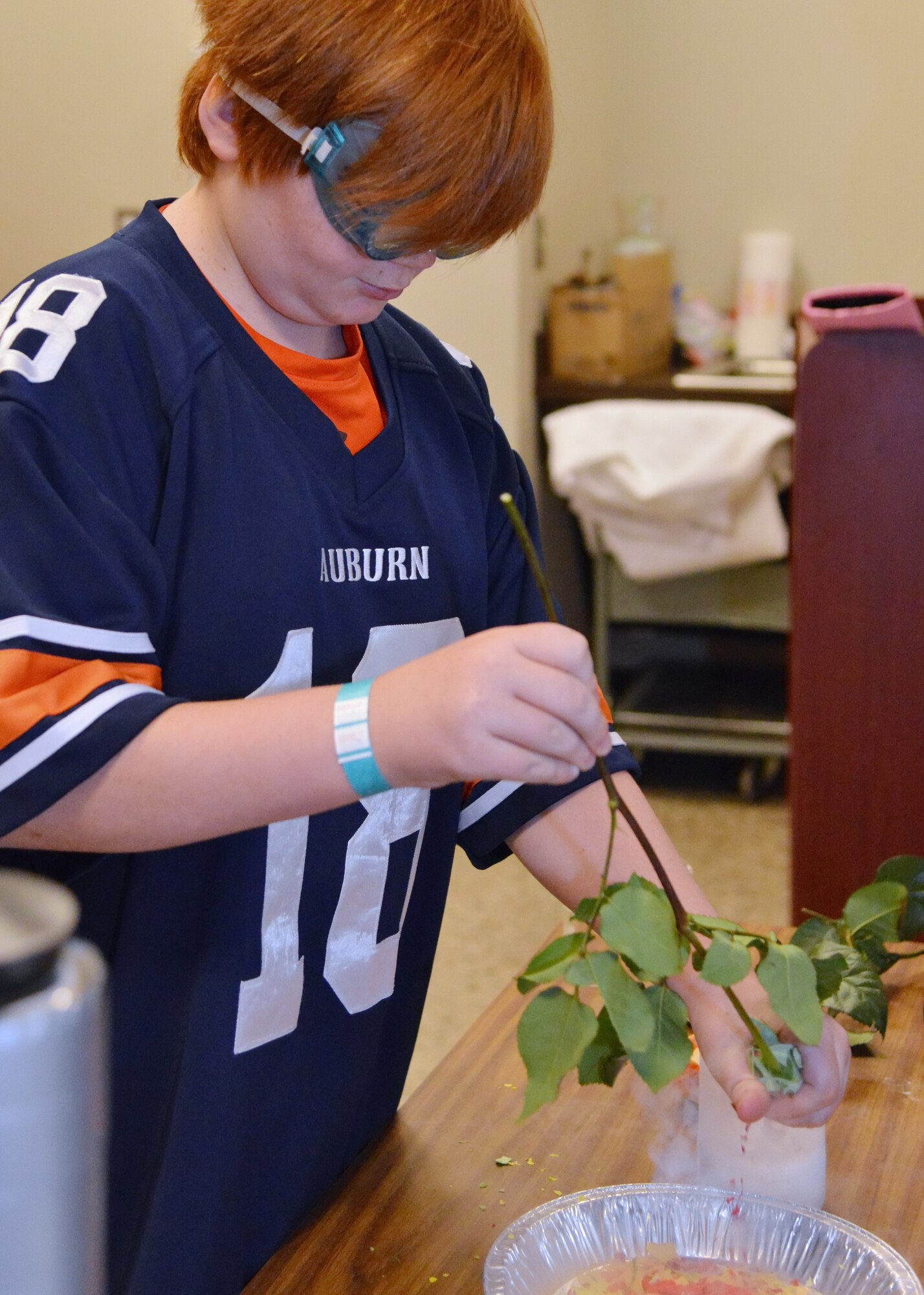 Ethan Franklin freezes a rose with liquid nitrogen at a STEM event Feb. 8 at the National Museum of Nuclear Science and History. (Photo by Jamie Burnett)