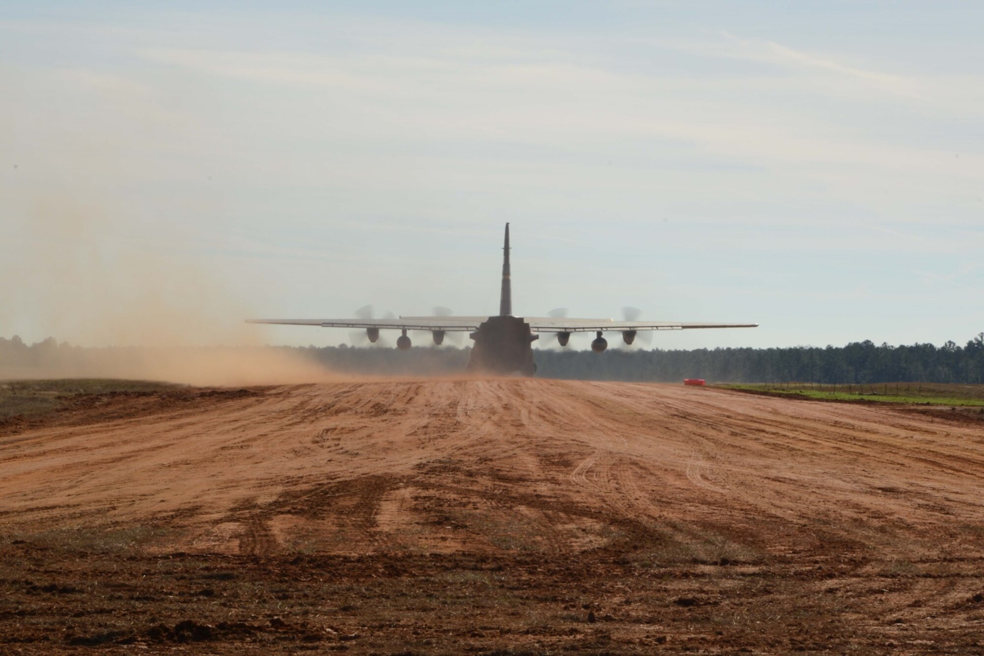 A C-130H Hercules aircraft assigned to the 103rd Airlift Wing prepares to take off from Ramagen dirt strip, Bryon County, Ga., Jan. 7, 2015. The aircraft was piloted by Lt. Col. Steve Gwinn and Maj. Josh Panis; both were qualifying for a special certification that permits them to land on short, unimproved runways. (U.S. Air National Guard photo by Senior Air-man Emmanuel Santiago)
