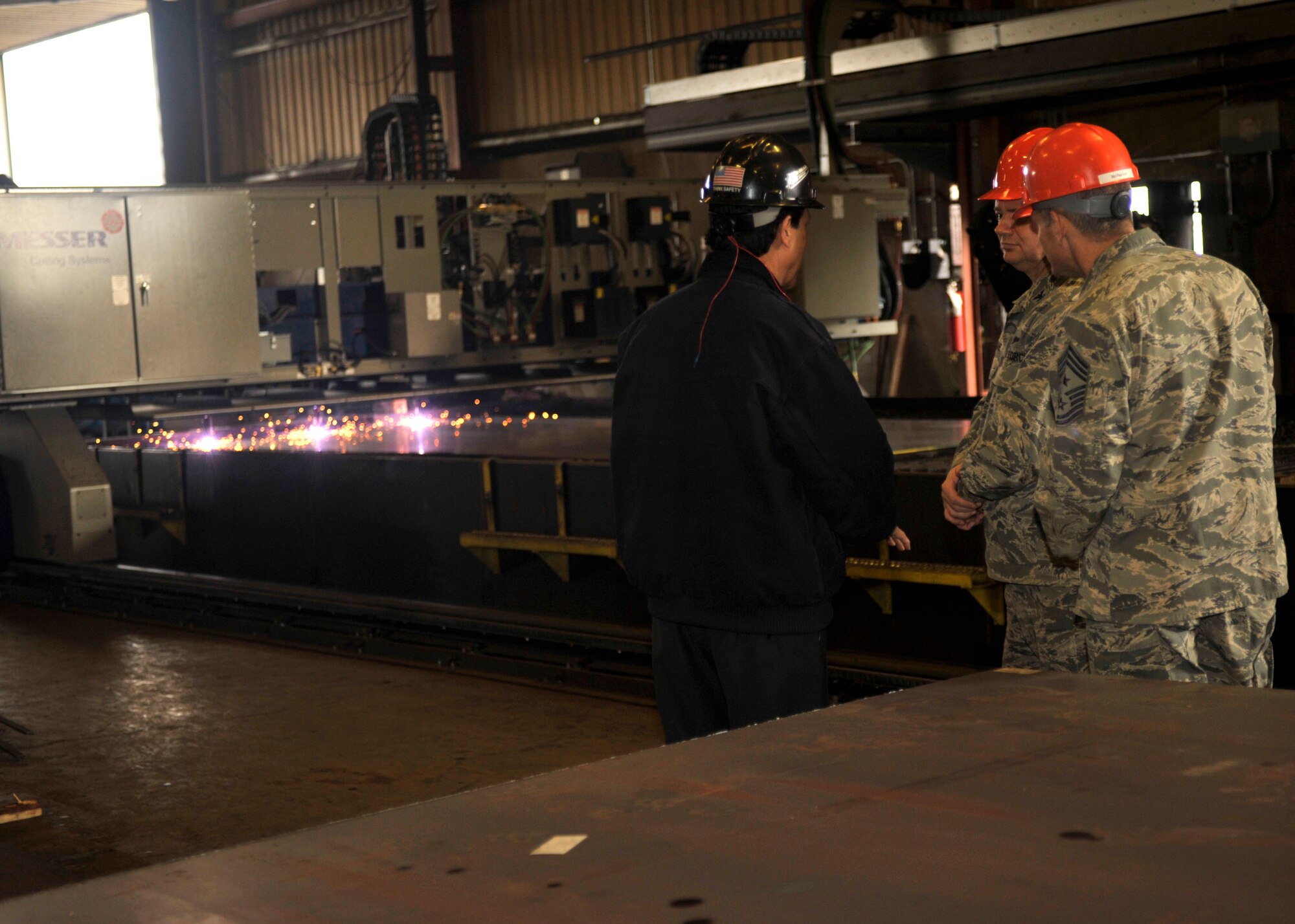 Craig Dias, Vice President of Haskins Steel Co. Inc., shows Col. Brian McDaniel, 92nd Air Refueling Wing commander, and Chief Master Sgt. Christian Pugh, 92nd Air Refueling Wing command chief, a Messer Cutting Systems cutting table Feb. 12, 2015, at Haskins Steel Co. Inc., Spokane Wash. McDaniel and Pugh toured the company’s facility as they’re one of many organizations that maintain a relationship with Fairchild Air Force Base. Haskins Steel is a close supporter of the base, providing financial support for Airman and family morale events as well as striving to ensure at least 20 percent of their staff are military veterans. (U.S. Air Force photo/Airman 1st Class Taylor Bourgeous)