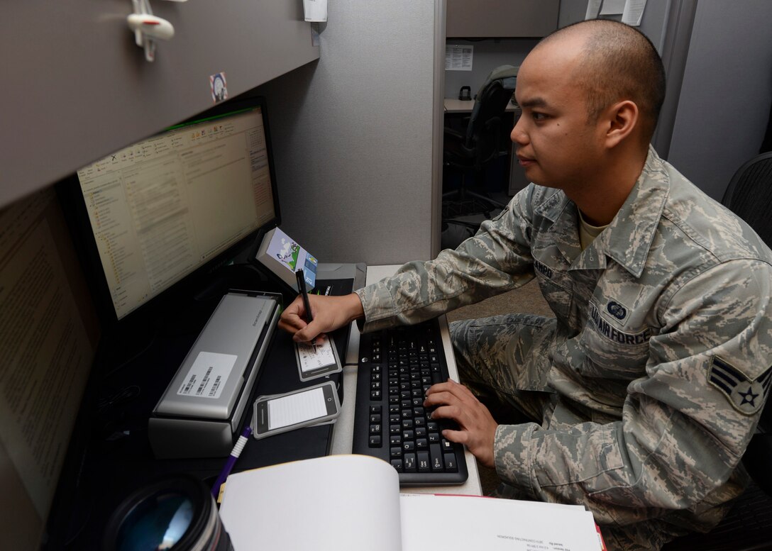 Senior Airman Robert Ocampo, 28th Contracting Squadron contract administrator, reviews contractual agreements at the 28th CONS office at Ellsworth Air Force Base, S.D., Jan. 22, 2015. Contract administrators review all contracts to ensure they comply with established guidelines prior to approval. (U.S. Air Force photo by Senior Airman Anania Tekurio/Released)  