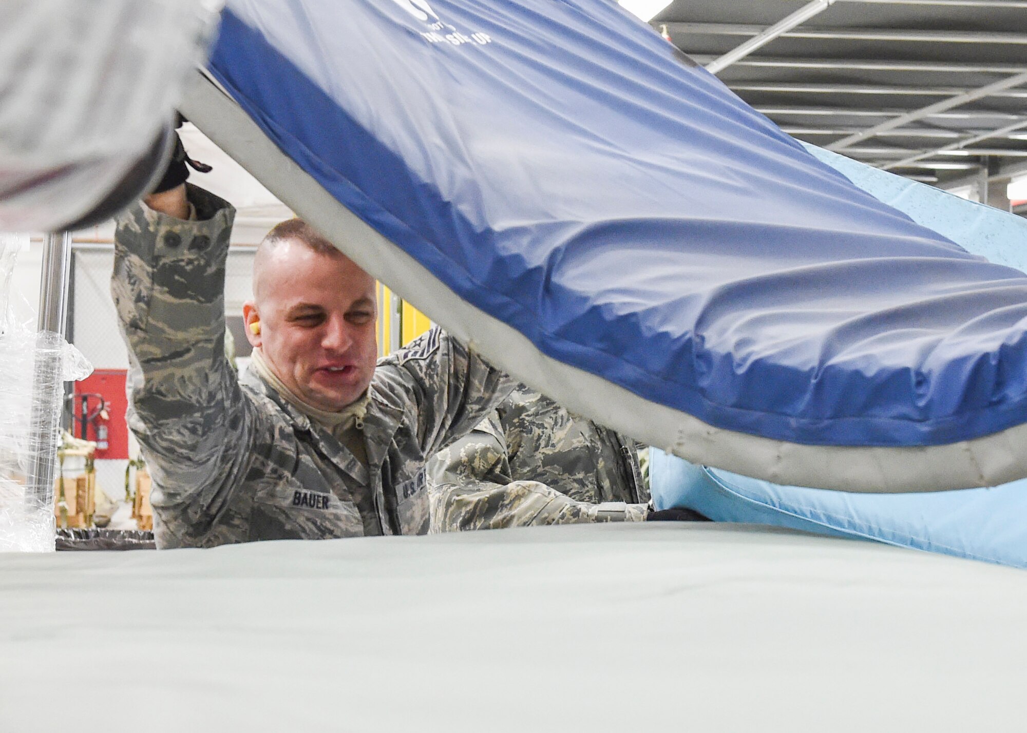 Air Force Reserve Tech. Sgt. Richard Bauer, an air transportation technician assigned to the 76th Aerial Port Squadron (APS), loads a mattress on a pallet during the Unit Training Assembly here, Feb. 7, 2015. The pallets were loaded for an upcoming Denton Mission to Honduras. U.S. Air Force photo/Senior Airman Rachel Kocin.