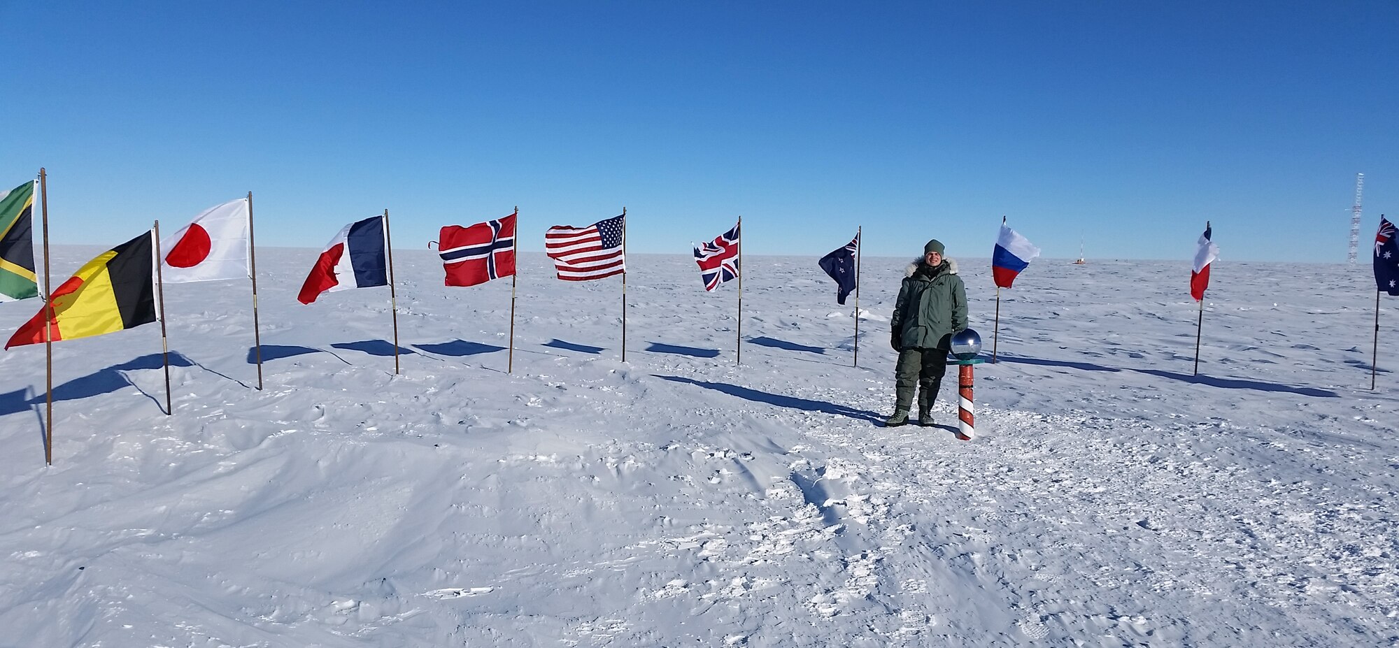 Senior Airman Lucas McEntire, an aircraft fuels systems mechanic with the 103rd Maintenance Squadron, stands next to the South Pole in Antarctica Nov. 14, 2014. The ceremonial pole is actually 100 feet from the geographical South Pole, said McEntire, and the temperature that day was minus 40 degrees, the exact temperature at which Centigrade and Fahrenheit are the same. (U.S. Air National Guard photo courtesy of Senior Airman Lucas McEntire)