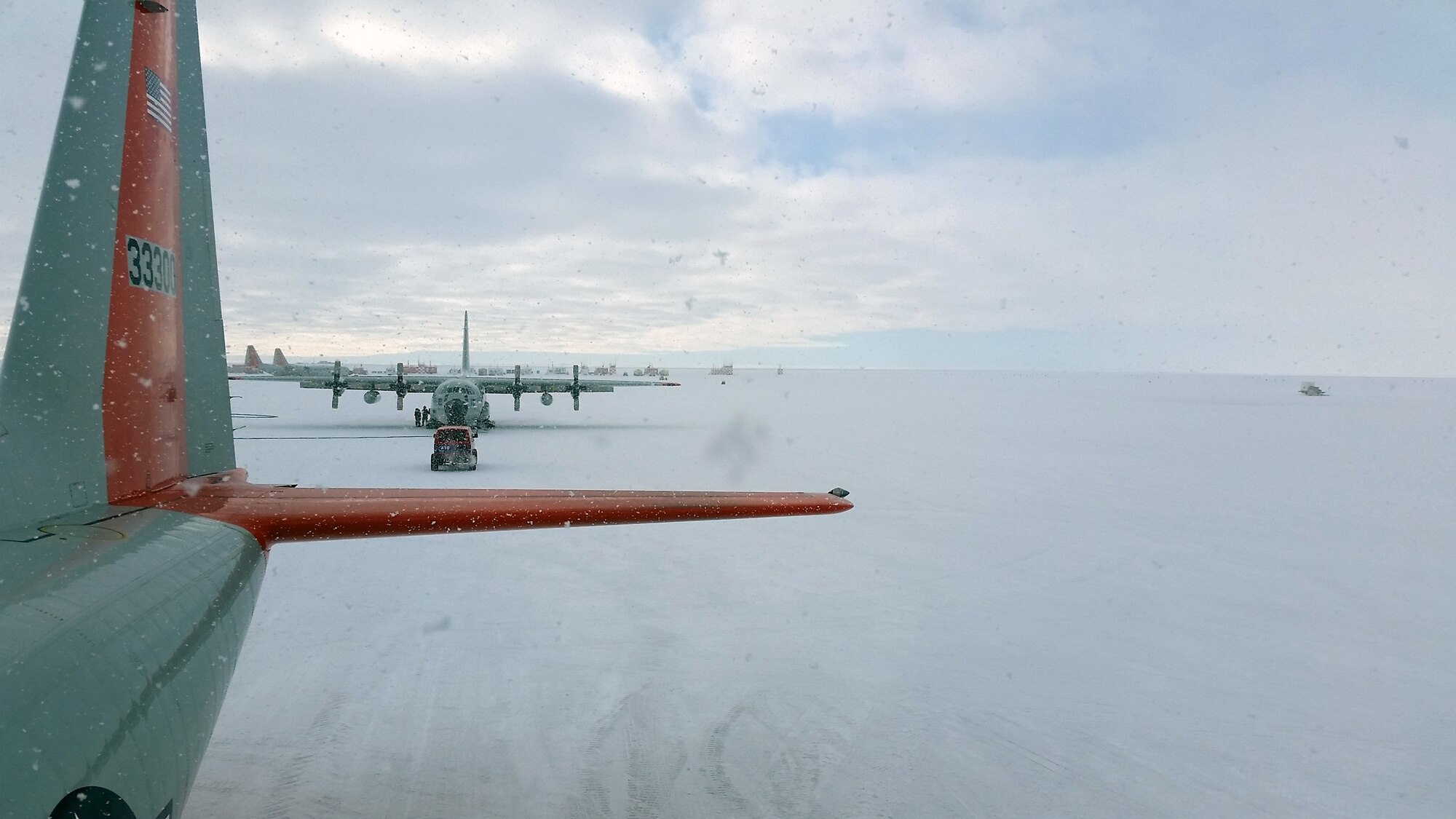 A C-130 Hercules aircraft sits at McMurdo Station, Antarctica, during a snow storm Nov. 13, 2014. Senior Airman Lucas McEntire, an aircraft fuels systems mechanic with the 103rd Mainte-nance Squadron, said he took the photo from on top of one of the C-130 aircraft that he was working on. (U.S. Air National Guard photo courtesy of Senior Airman Lucas McEntire)