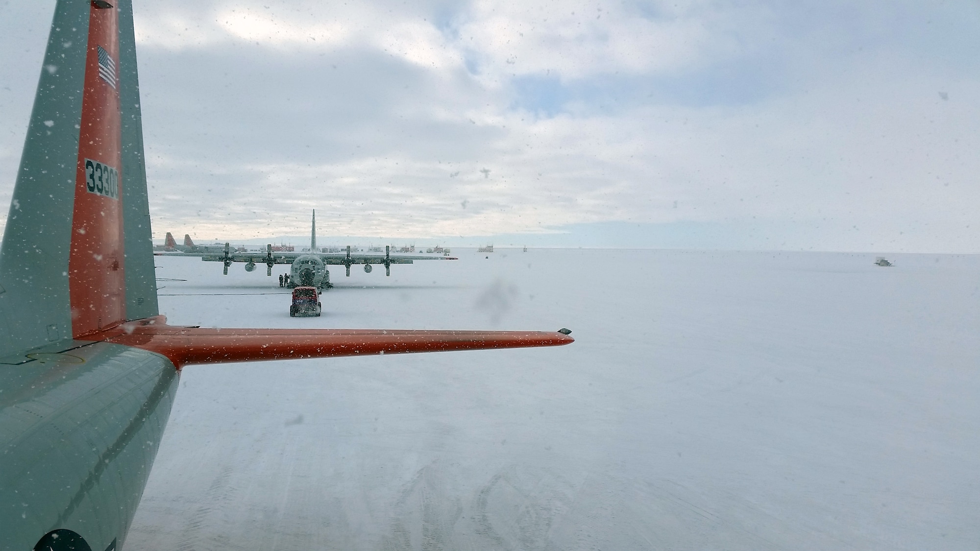 A C-130 Hercules aircraft sits at McMurdo Station, Antarctica, during a snow storm Nov. 13, 2014. Senior Airman Lucas McEntire, an aircraft fuels systems mechanic with the 103rd Mainte-nance Squadron, said he took the photo from on top of one of the C-130 aircraft that he was working on. (U.S. Air National Guard photo courtesy of Senior Airman Lucas McEntire)