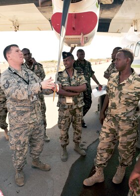 U.S. Air Force Tech. Sgt. Albert Kirkey, 818th Mobility Support Advisory Squadron aircraft maintenance adviser, talks with Djiboutian air force members about maintenance procedures for the Let L-410 Turbolet aircraft during African Partnership Flight???Djibouti at Djibouti Air Base, Feb. 9, 2015. African Partnership Flight is the premiere program to bring together partner nations to increase cooperation and interoperability, which fosters stability and security throughout the continent. (U.S. Air Force Photo by Tech. Sgt. Ian Dean)