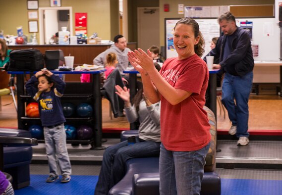 U.S. Air Force Tech. Sgt. Shannon Cole, 23d Maintenance Group supply liaison, cheers during the Exceptional Family Members Program’s bowling camp Feb. 11, 2015, at Moody Air Force Base, Ga. During the six-week camp, Cole coached a team of four children. (U.S. Air Force photo by Airman 1st Class Ceaira Tinsley/Released)