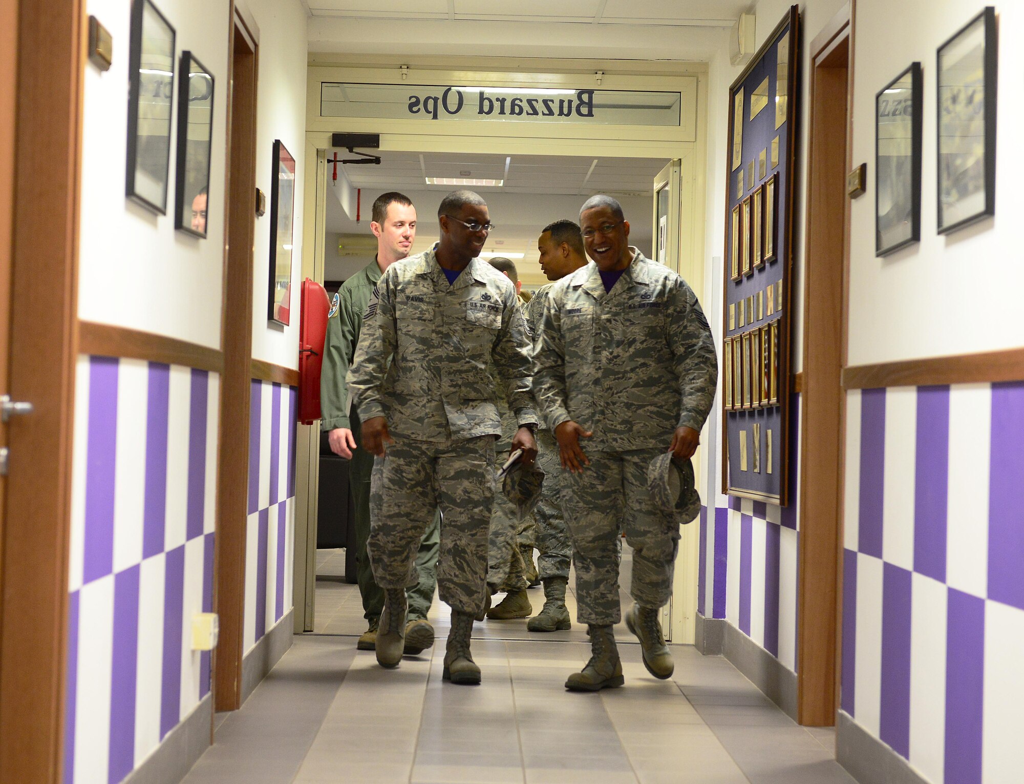 Chief Master Sgt. James Davis, U.S. Air Forces in Europe and Air Forces Africa command chief, speaks with Master Sgt. Andre Moore, 510th Fighter Squadron superintendent, Feb. 13, 2015, during a visit to Aviano Air Base, Italy. Davis toured several units around base and recognized outstanding Airmen. (U.S. Air Force photo by Senior Airman Matthew Lotz/Released)