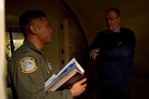 A missileer from the 742d Missile Squadron gives Deputy Secretary of Defense Bob Work a briefing before entering the launch control center of a missile alert facility in North Dakota, Feb. 11, 2015. During his visit to Minot Air Force Base, N.D., Work also received tours of the weapons storage area, a B-52H Stratofortress and Uniform-01.  (U.S. Air Force photo/Senior Airman Brittany Y. Bateman)