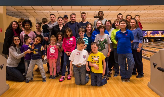 Members of the Exceptional Family Members Program pose for a photo during the EFMP’s bowling camp Feb. 11, 2015, at Moody Air Force Base, Ga. EFMP connects active duty family members who have special needs with different agencies both on and off base. (U.S. Air Force photo by Airman 1st Class Ceaira Tinsley/Released)