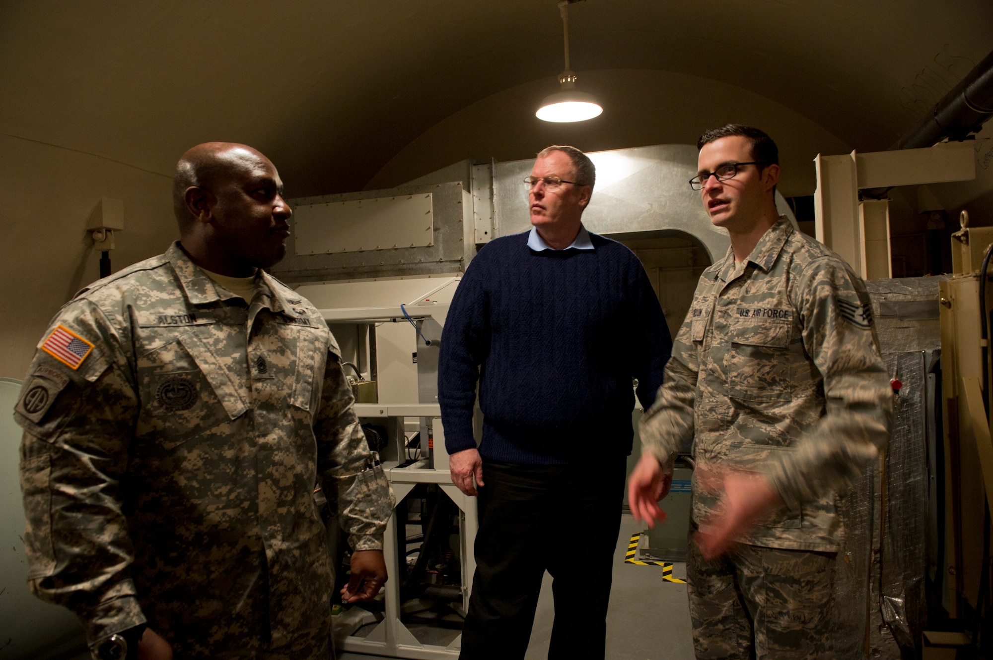 Staff Sgt. Joshua Gibson, 742d Missile Squadron alert facility manager, gives Deputy Secretary of Defense Bob Work and Command Sgt. Maj. Patrick Alston, senior enlisted leader for the United States Strategic Command, Offutt Air Force Base, Neb., a tour of a missile alert facility in North Dakota, Feb. 11, 2015. During their visit to Minot Air Force Base, N.D., they also received tours of the weapons storage area, a B-52H Stratofortress and Uniform-01. (U.S. Air Force photo/Senior Airman Brittany Y. Bateman)