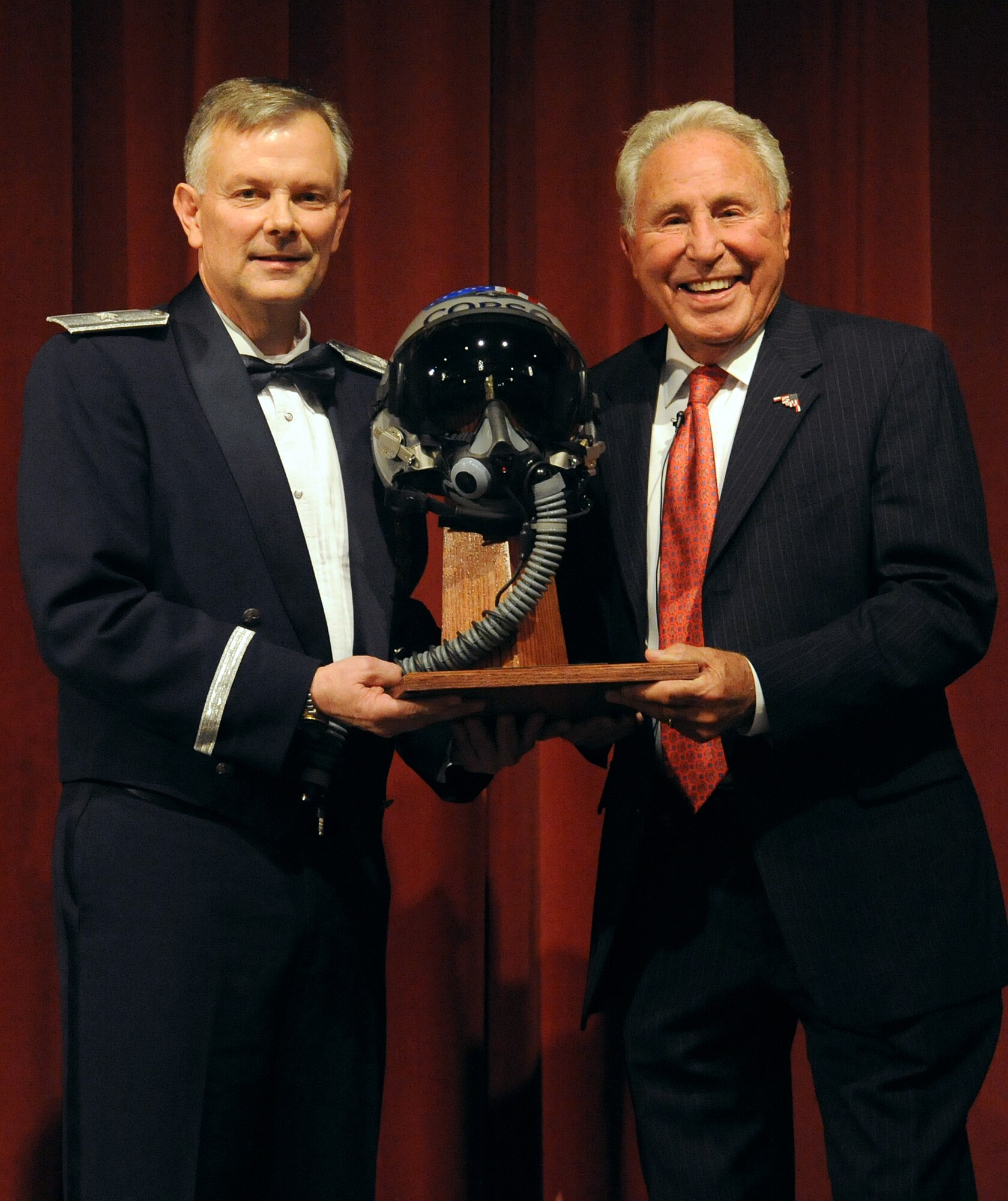 Brig. Gen. Glen D. VanHerck, the 509th Bomb Wing commander, presents Lee Corso, an ESPN college football analyst, a memento on behalf of Team Whiteman for speaking at the 2014 Annual Awards Banquet in Warrensburg, Mo., Feb. 6, 2015. Corso was the guest speaker during this year’s Annual Awards Banquet. (U.S. Air Force photo by Airman 1st Class Jovan Banks/Released)