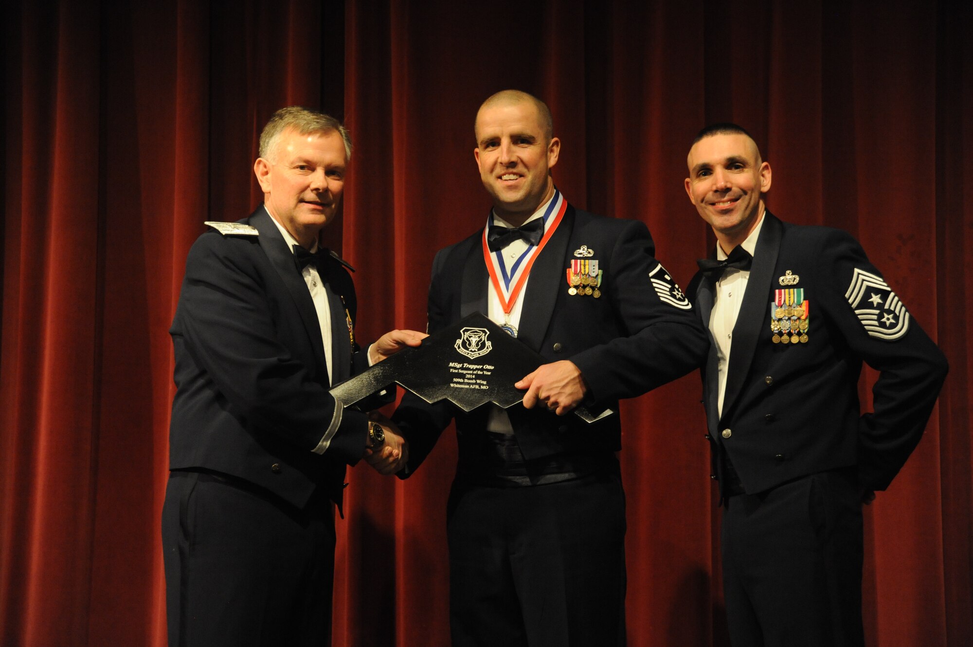 Master Sgt. Trapper Otto, First Sergeant of the 509th Operation Support Squadron, accepts the 2014 First Sergeant of the Year award at Warrensburg, Mo., Feb. 6, 2015. Otto was one of 13 award recipients at the Annual Awards Banquet. (U.S. Air Force photo by Airman 1st Class Jovan Banks/Released)