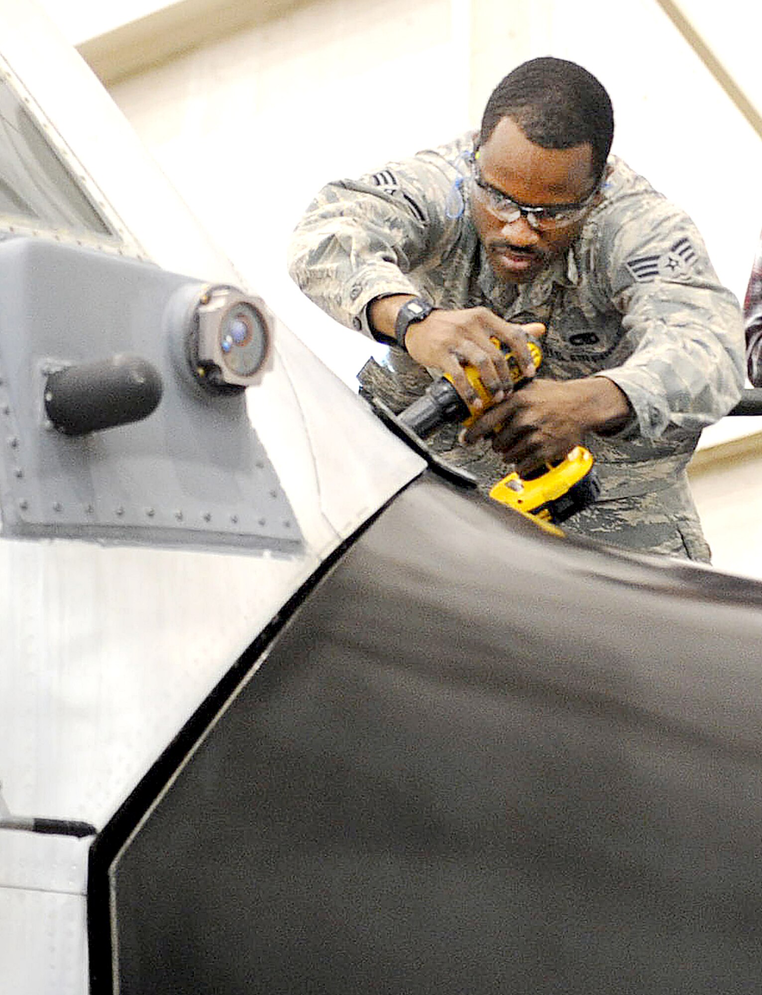 Senior Airman Vincent Senegar, 908th Aircraft Maintenance Squadron, installs its nose radome hinge cover. (U.S. Air Force photo by Tommie Horton)