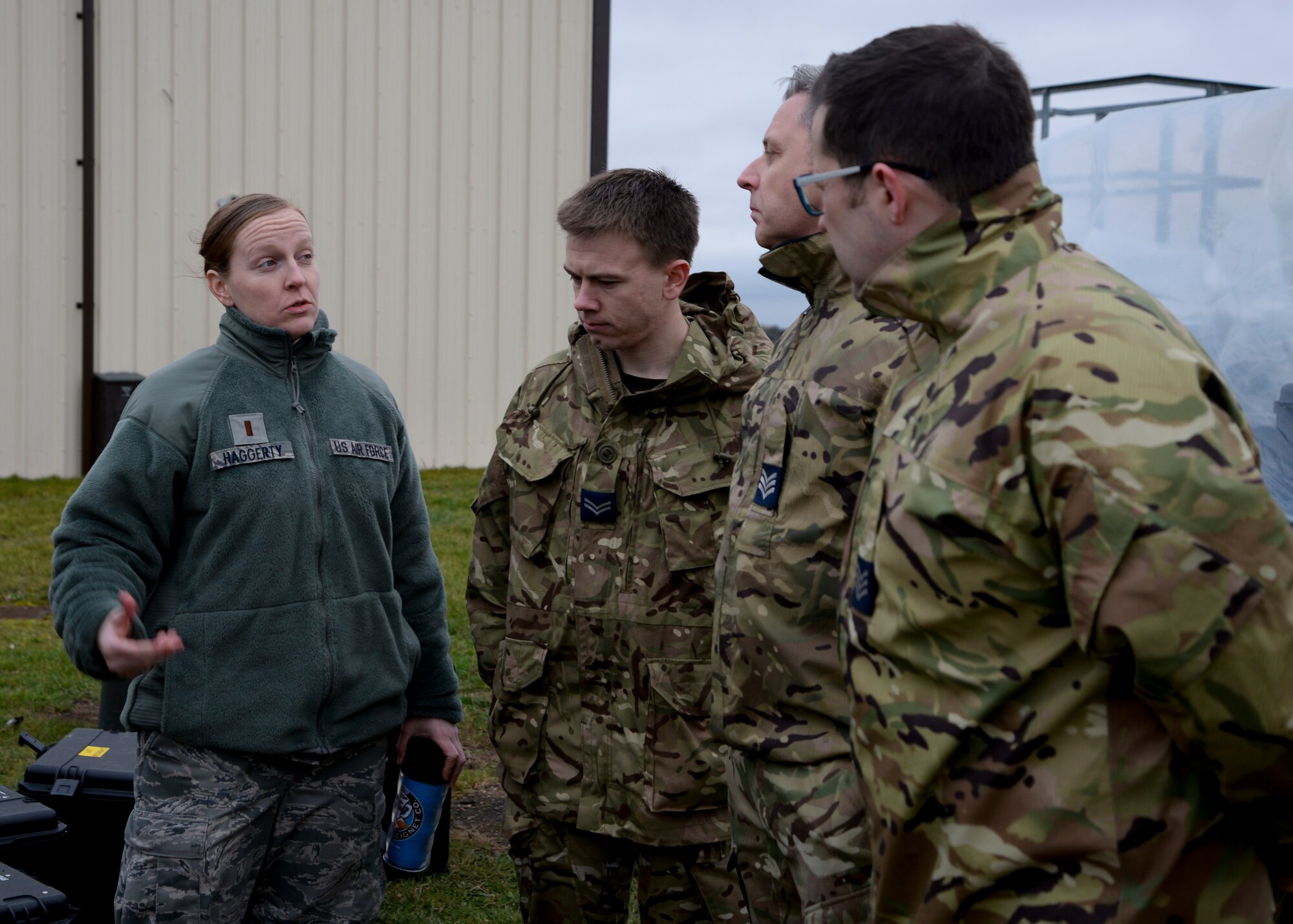 U.S. Air Force 2nd Lt. Rebecca Haggerty, left, 352nd Special Operations Support Squadron officer in charge of tactical communications from Boston, Mass., speaks with service members from RAF Leeming during a deployment exercise Jan. 28, 2015, on RAF Mildenhall, England. One purpose of the demonstration was to strengthen operational ties between the 90th Signals Detachment tactical communications teams and the 352nd SOSS teams. (U.S. Air Force photo by Senior Airman Victoria H. Taylor/Released)
