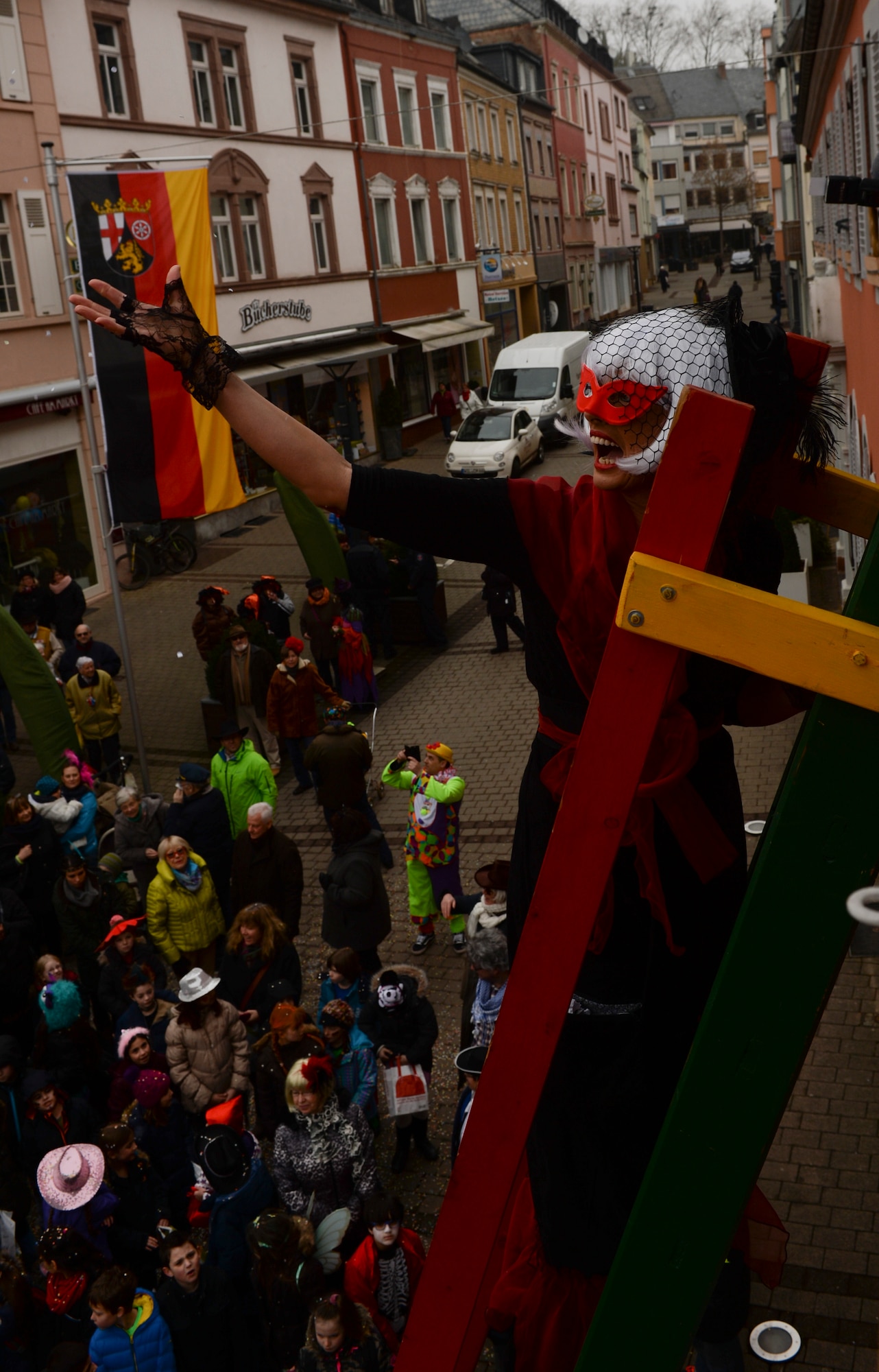 A citizen of Wittlich, Germany, throws confetti off of a ladder while climbing up to a window of city hall during a Fasching celebration in Wittlich, Germany, Feb. 12, 2015. The celebration included a tradition of female citizens storming the city hall to seize control of the community for the day. (U.S. Air Force Photo by Staff Sgt. Joe W. McFadden/Released)
 
