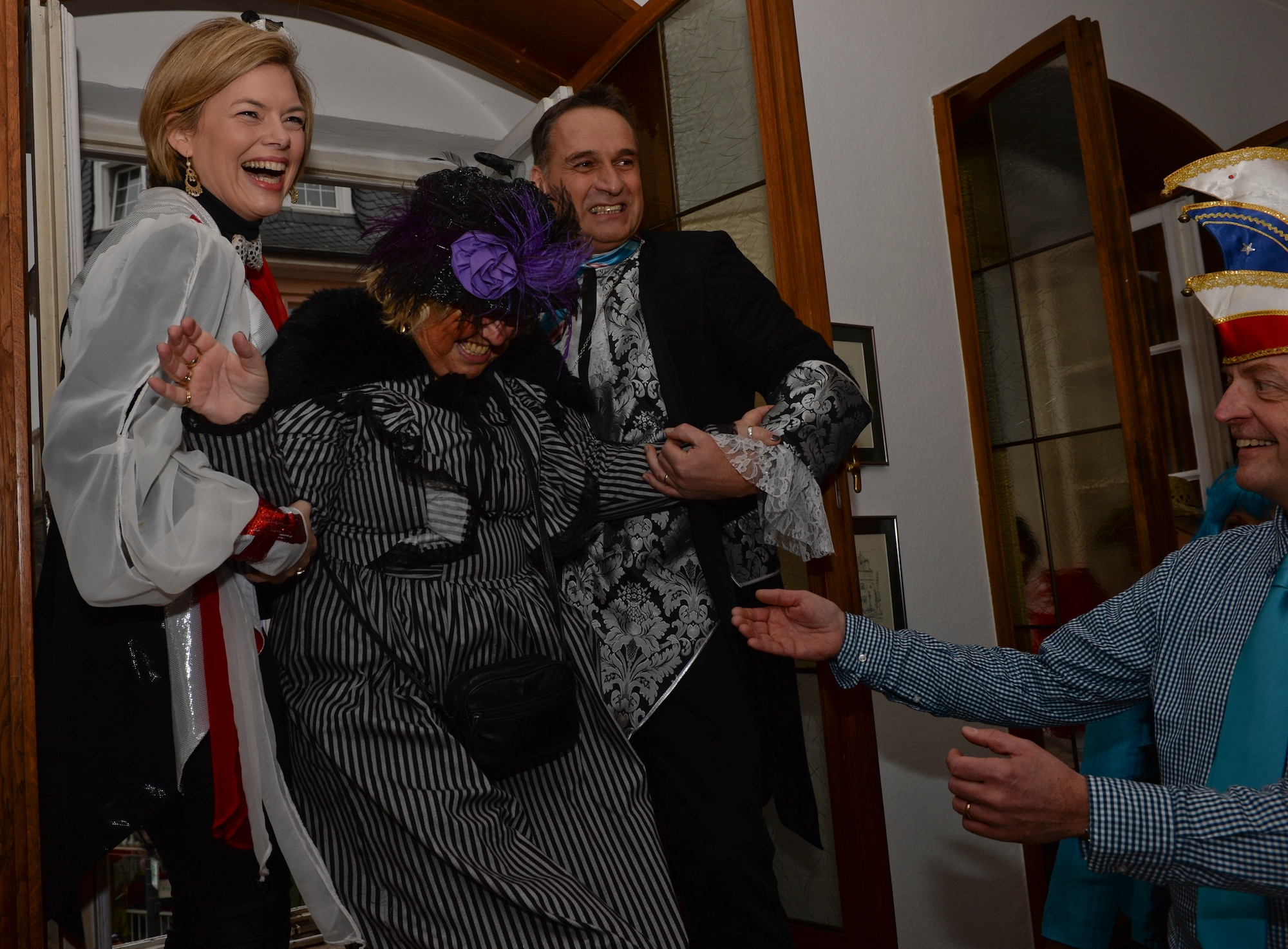 Julia Kloeckner, leader of the opposition of the Rheinland-Pfalz Landtag, left, and Joachim Rodenkirch, mayor of Wittlich, Germany, center right, help a citizen through the window of city hall during a Fasching celebration in Wittlich, Germany, Feb. 12, 2015. The celebration included a tradition of female citizens storming the city hall to seize control of the community for the day. (U.S. Air Force Photo by Staff Sgt. Joe W. McFadden/Released)
 

