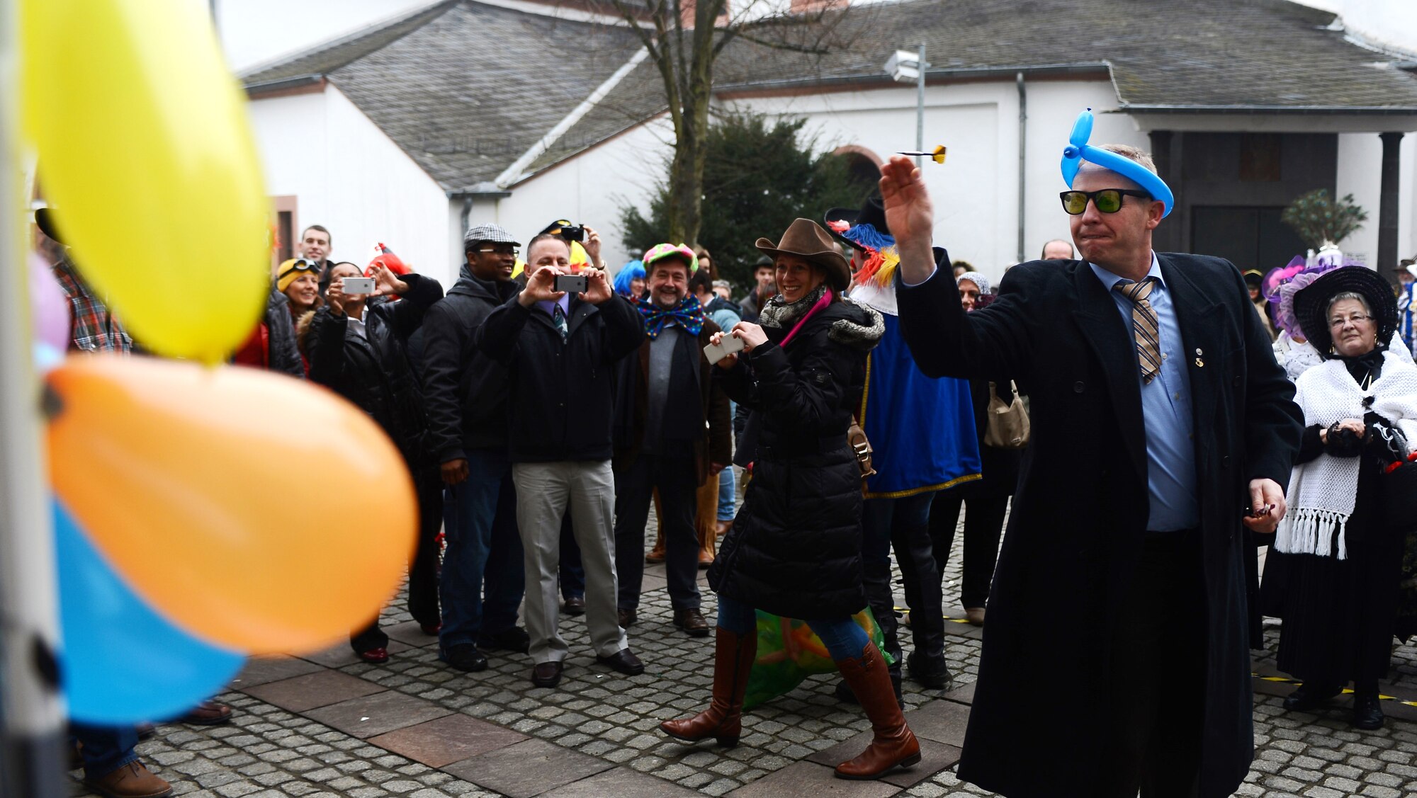 U.S. Air Force Col. Joseph McFall, 52nd Fighter Wing commander, throws a dart during the 2015 Storming of the Rathaus Fasching event in Bitburg, Germany, Feb. 12, 2015. McFall, along with other leadership members of the 52nd FW, participated in several events throughout the day to celebrate the holiday tradition. (U.S. Air Force photo by Airman 1st Class Luke Kitterman/Released)