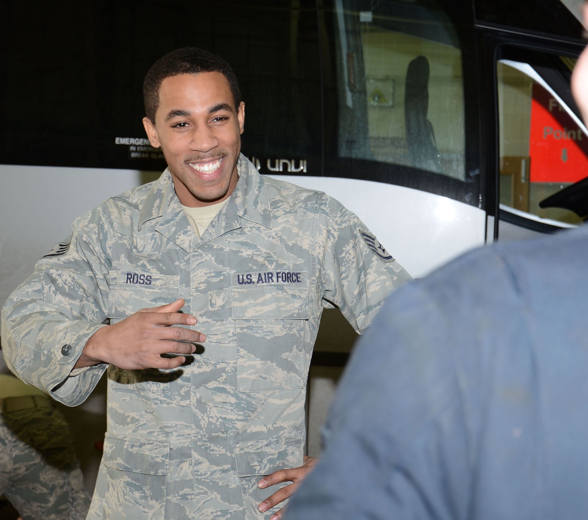 U.S. Air Force Staff Sgt. Jayme Ross, left, 100th Logistics Readiness Squadron Allied Trades NCO in charge from Hartford, Conn., briefs U.S. Air Force Airman 1st Class Luke Hodge, 100th LRS material-handling vehicle technician from Glen Daniel, W.Va., on how to safely change split rim tires Feb. 6, 2015, on RAF Mildenhall, England. Ross is an example of how positive energy brought to a work center can spread to the Airmen he leads. (U.S. Air Force photo by Gina Randall/Released)