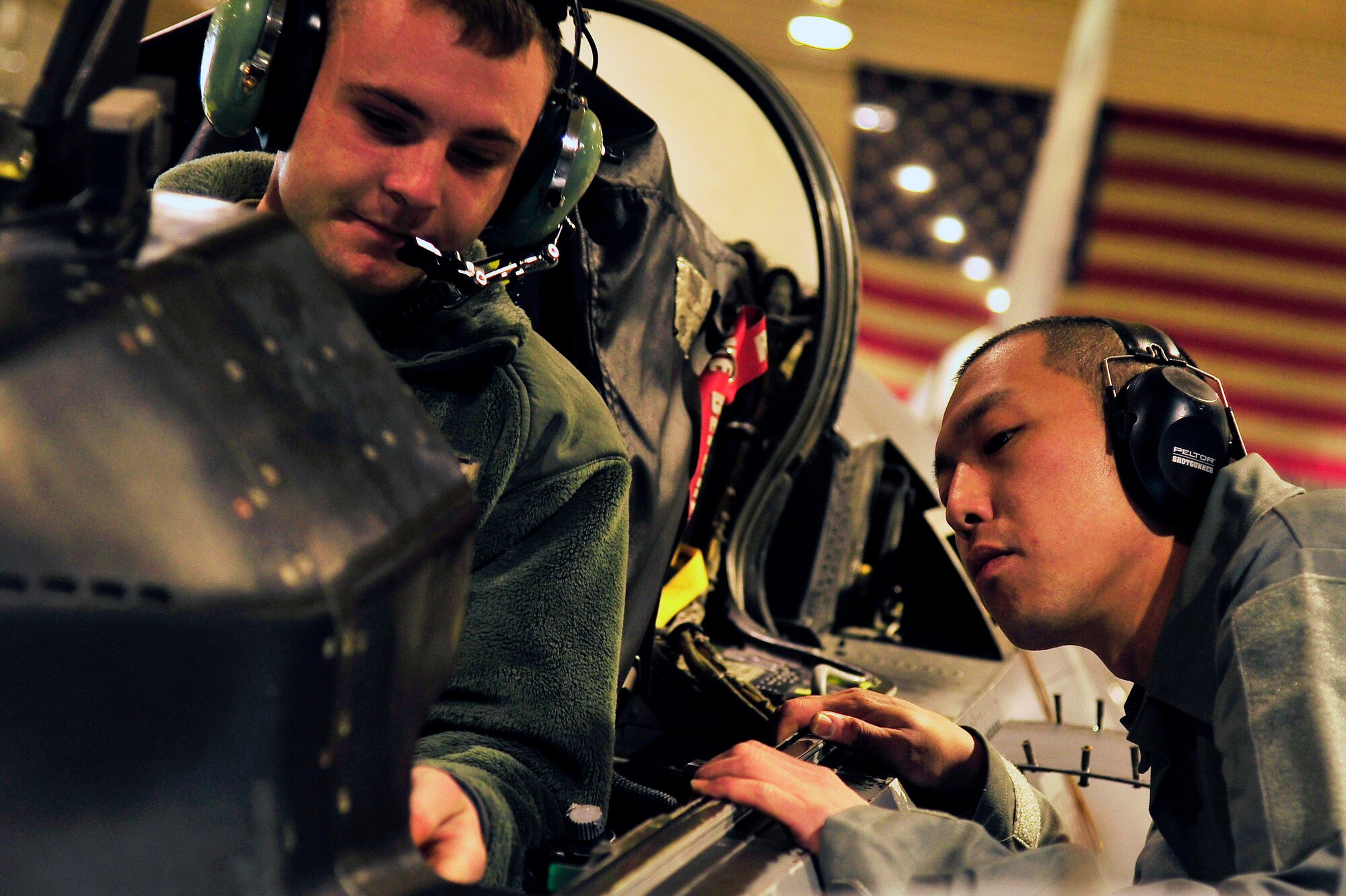 U.S. Air Force Airman 1st Class Jesse Wilcox, 13th Aircraft Maintenance Unit crew chief, explains panels in the cockpit of an F-16 Fighting Falcon to Japanese Air Self-Defense Force Staff Sgt. Ryo Omi, U-125A crew chief from Komaki Air Base’s Air Rescue Squadron, at Misawa Air Base, Japan, Feb. 6, 2015. Omi spent two weeks with Misawa maintainers as part of the Bilateral Exchange Program, which allows American and Japanese Airmen within similar career fields an opportunity to learn skills and techniques from each other.  (U.S. Air Force photo by Tech. Sgt. April Quintanilla)