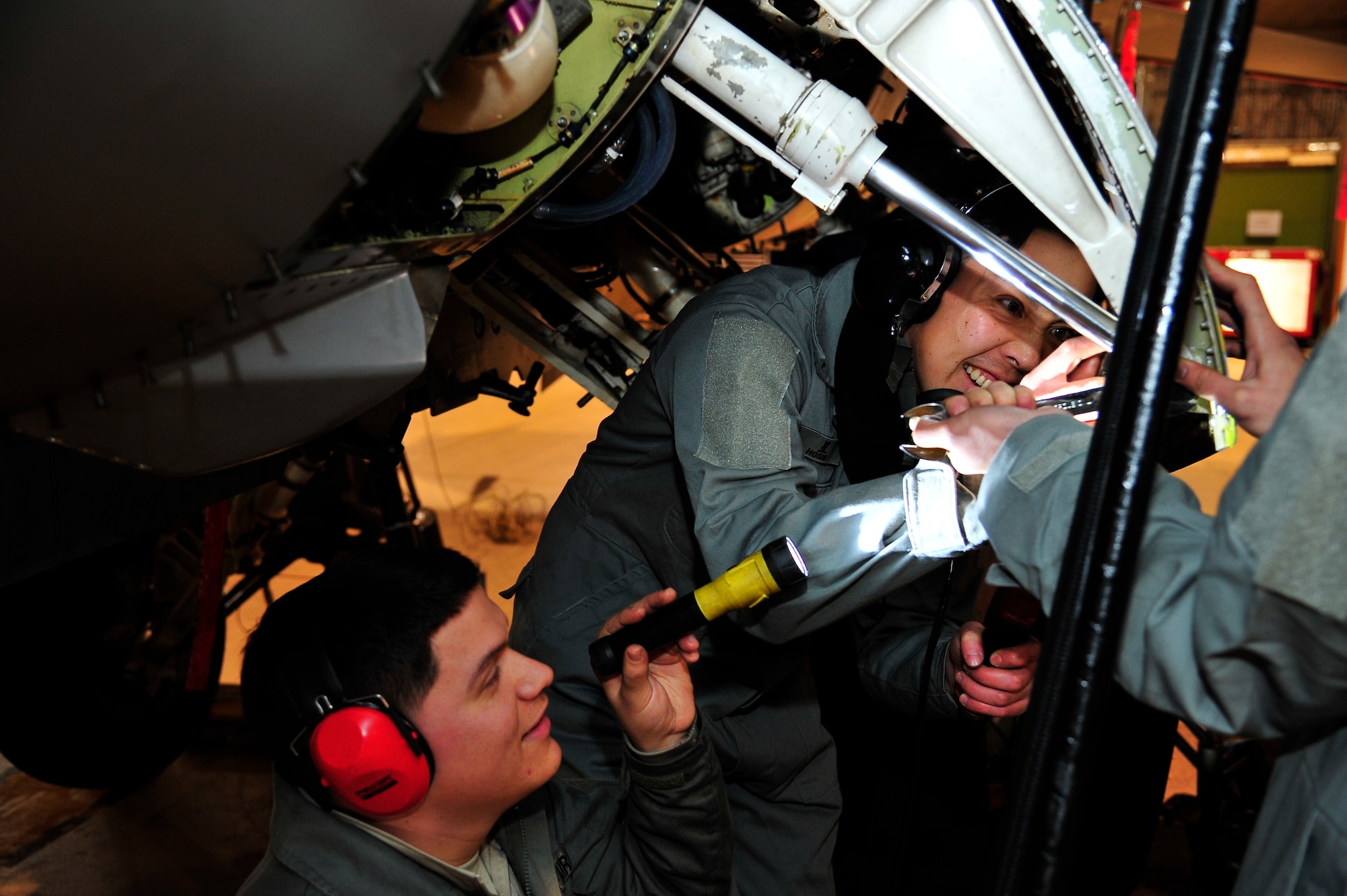 U.S. Air Force Staff Sgt. Cody Puente, 35th Maintenance Squadron, and Japanese Air Self-Defense Force Tech. Sgt. Yuji Hoshi, 3rd Fighter Squadron F-2 crew chief, work together to close the panel of an F-16 Fighting Falcon at Misawa Air Base, Japan, Feb. 6, 2015. Puente and Hoshi were able to work side-by-side as part of the two-week long Bilateral Exchange Program hosted Feb. 2-13. The program gives American and Japanese service members in similar career fields the opportunity to work together and share different work techniques. (U.S. Air Force photo by Tech. Sgt. April Quintanilla)