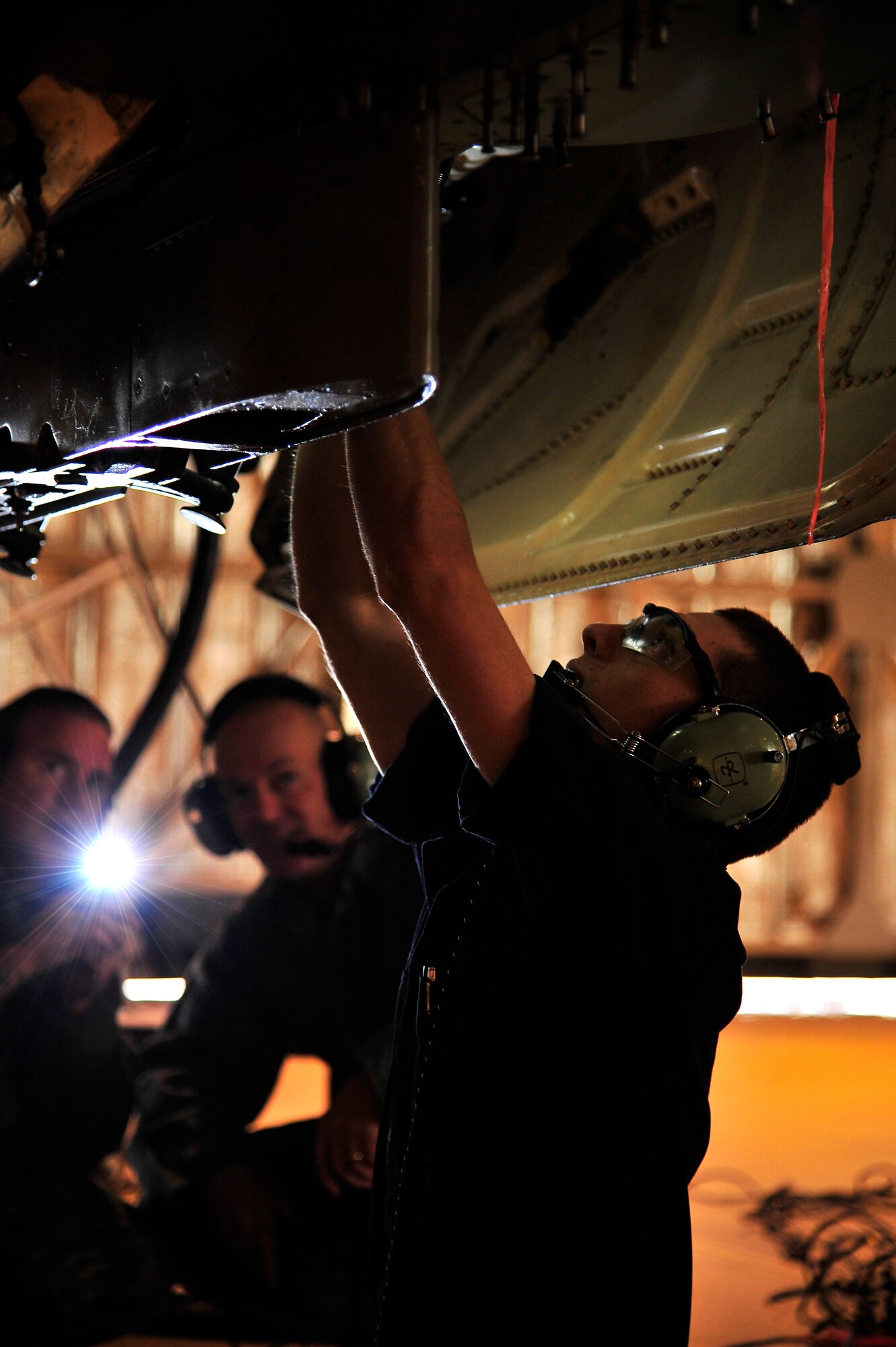 U.S. Air Force Tech. Sgt. Ryan Campbell, 35th Maintenance Squadron phase dock NCO in charge, and Col. Andrew Hansen 35th Fighter Wing vice commander, watch as Staff Sgt. Sean Williams, maintainer attached to the 35 MXS, works on an F-16 Fighting Falcon at Misawa Air Base, Japan, Feb. 6, 2014. Campbell and Williams were two of several Airmen within the maintenance field to participate in Bilateral Exchange Program Feb. 2-13. The program brings American Airmen and members of the Japan Self-Defense Force within similar career fields together three times a year to see how the other operates, and bring lessons learned back to their respective Forces. (U.S. Air Force photo by Tech. Sgt. April Quintanilla)