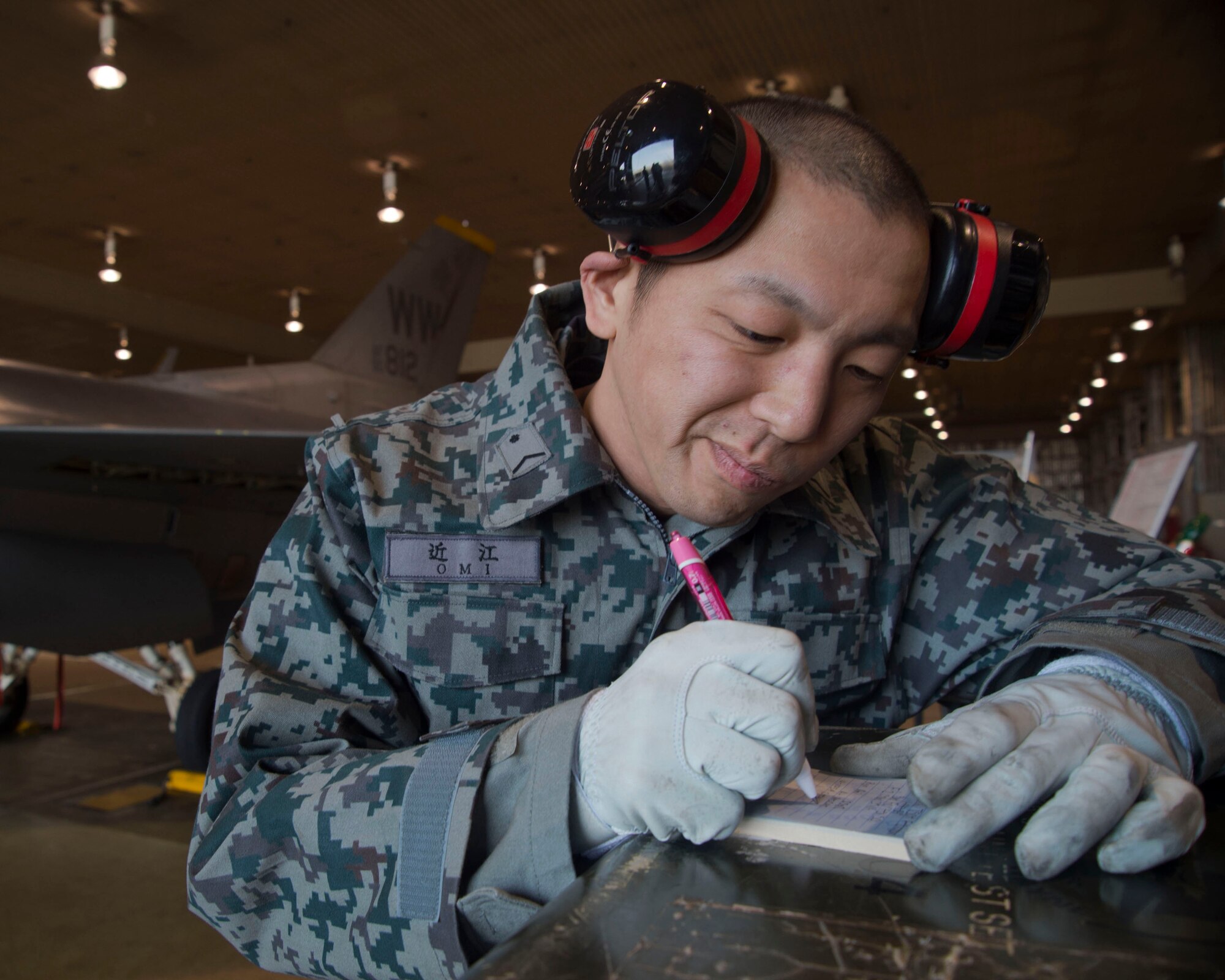 Japanese Air Self-Defense Force Staff Sgt. Ryo Omi, U-125A crew chief from Komaki Air Base’s Air Rescue Squadron, writes down information after performing maintenance on an F-16 Fighting Falcon with members of the 35th Maintenance Squadron at Misawa Air Base, Japan, Feb. 11, 2015. Omi was one of several JASDF members who integrated with Misawa maintainers during the most recent Bilateral Exchange Program. The program began in 1996 to allow American and Japanese Forces the opportunity to work together and learn from each other’s daily operations. Almost 20 years later, the program still brings the Forces together three times a year. (U.S. Air Force photo by Staff Sgt. Alyssa C. Wallace)