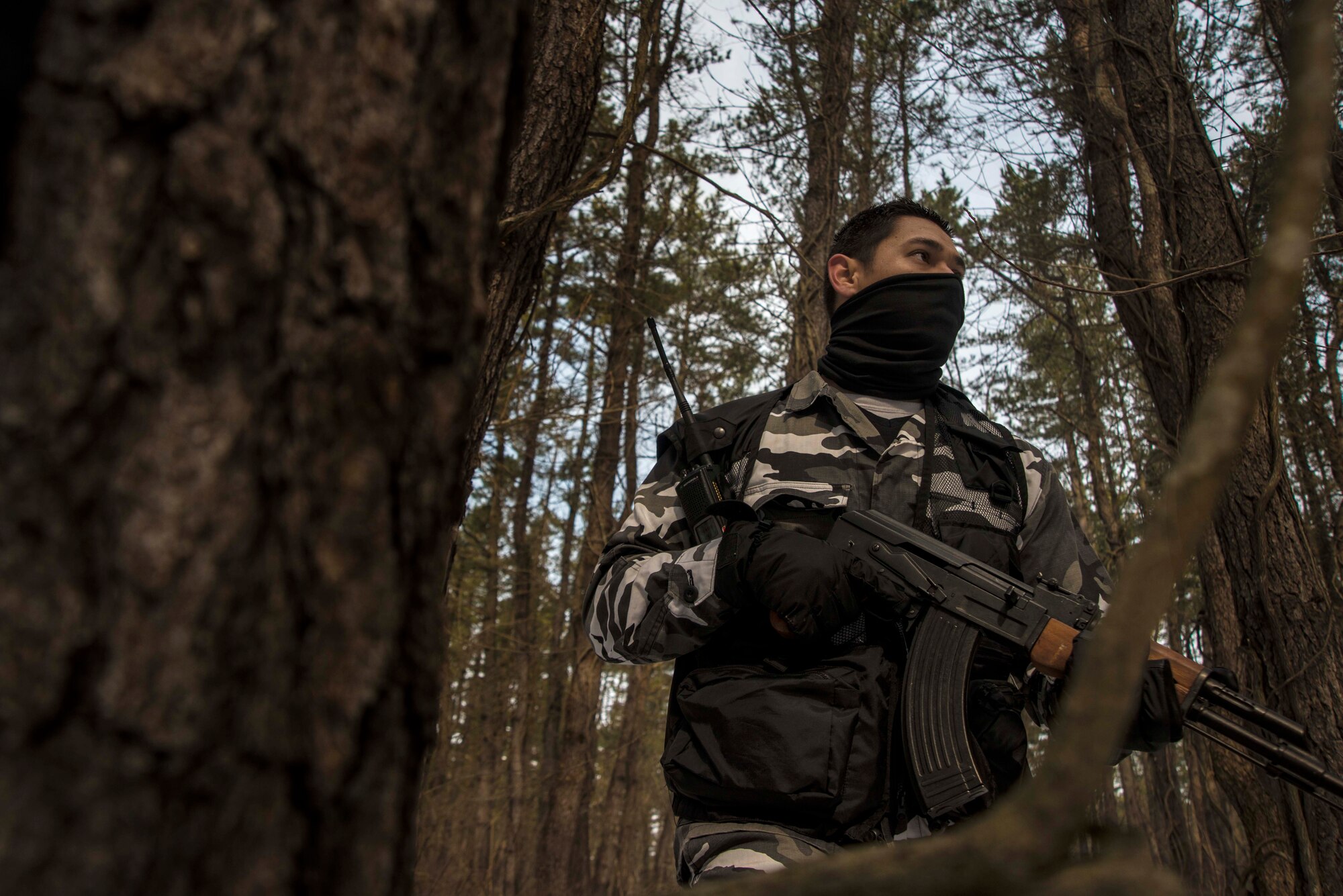 Matthew Dye, 14th Fighter Squadron opposing forces member, patrols dense forest in search of downed pilots during a Survival, Evasion, Resistance and Escape exercise Feb. 12, 2015, at Draughon Range outside Misawa Air Base, Japan. Each month, Misawa's F-16 Fighting Falcon pilots use this traiing to gain realisitic experience in evading enemy capture if their aircraft were to go down in hostile territory. (U.S. Air Force photo by Staff Sgt. Derek VanHorn)