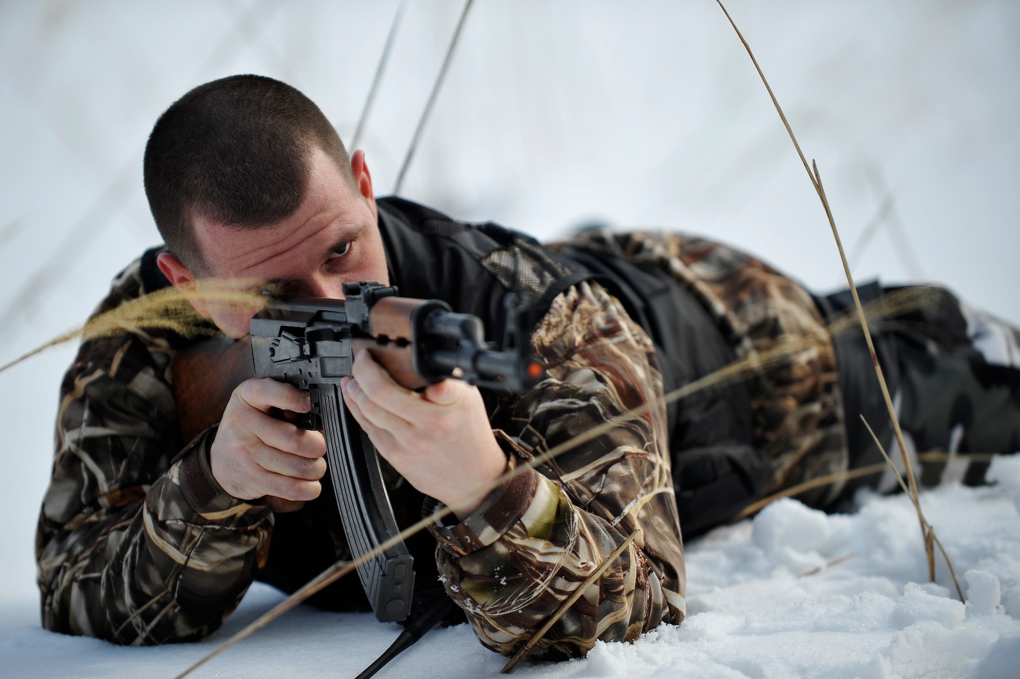 U.S. Air Force Staff Sgt. James Thompson, 35th Operations Support Squadron opposing forces member, searches down range for a downed pilot during Survival, Evasion, Resistance and Escape training for pilots at the Draughon Range outside Misawa Air Base, Japan, Feb. 12, 2015. Thompson served as an opposing forces member charged with tracking down and finding pilots. This training was executed for F-16 Fighting Falcon pilots who must continually complete SERE training to ensure combat survival readiness. (U.S. Air Force photo by Senior Airman Jose L. Hernandez-Domitilo)