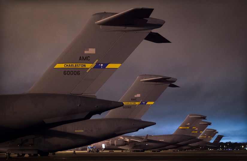 C-17 Globemaster IIIs line the ramp at dusk, Feb. 11, 2015, at Joint Base Charleston, S.C. Maintainers perform checks and maintenance on the aircraft day and night to ensure the aircraft are ready to fly. (U.S. Air Force photo/Senior Airman Dennis Sloan)