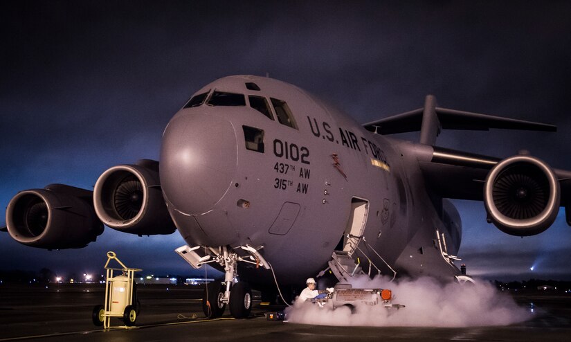 Airman Daniel Giulian, 437th Aircraft Maintenance Squadron crew chief, transfers liquid oxygen from a tank to a C-17 Globemaster III at dusk on Feb. 11, 2015, at Joint Base Charleston, S.C. When exposed to open air, the minus-297-degree LOX evaporates into a gas. Liquid oxygen is used as a means of distributing breathable air to aircrew members and passengers above 10,000 feet above sea level. The C-17 can hold approximately 155 gallons of LOX. (U.S. Air Force photo/Senior Airman Dennis Sloan)
