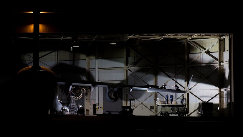 Airmen from the 437th Aircraft Maintenance Squadron use a spotlight to illuminate the inside of a hangar at night, so they are able to perform maintenance on a C-17 Globemaster III Feb. 11, 2015, at Joint Base Charleston, S.C. AMXS Airmen work day and night maintaining the Charleston C-17 fleet and use various portable lighting systems to make nighttime maintenance possible. (U.S. Air Force photo/ Senior Airman Dennis Sloan
