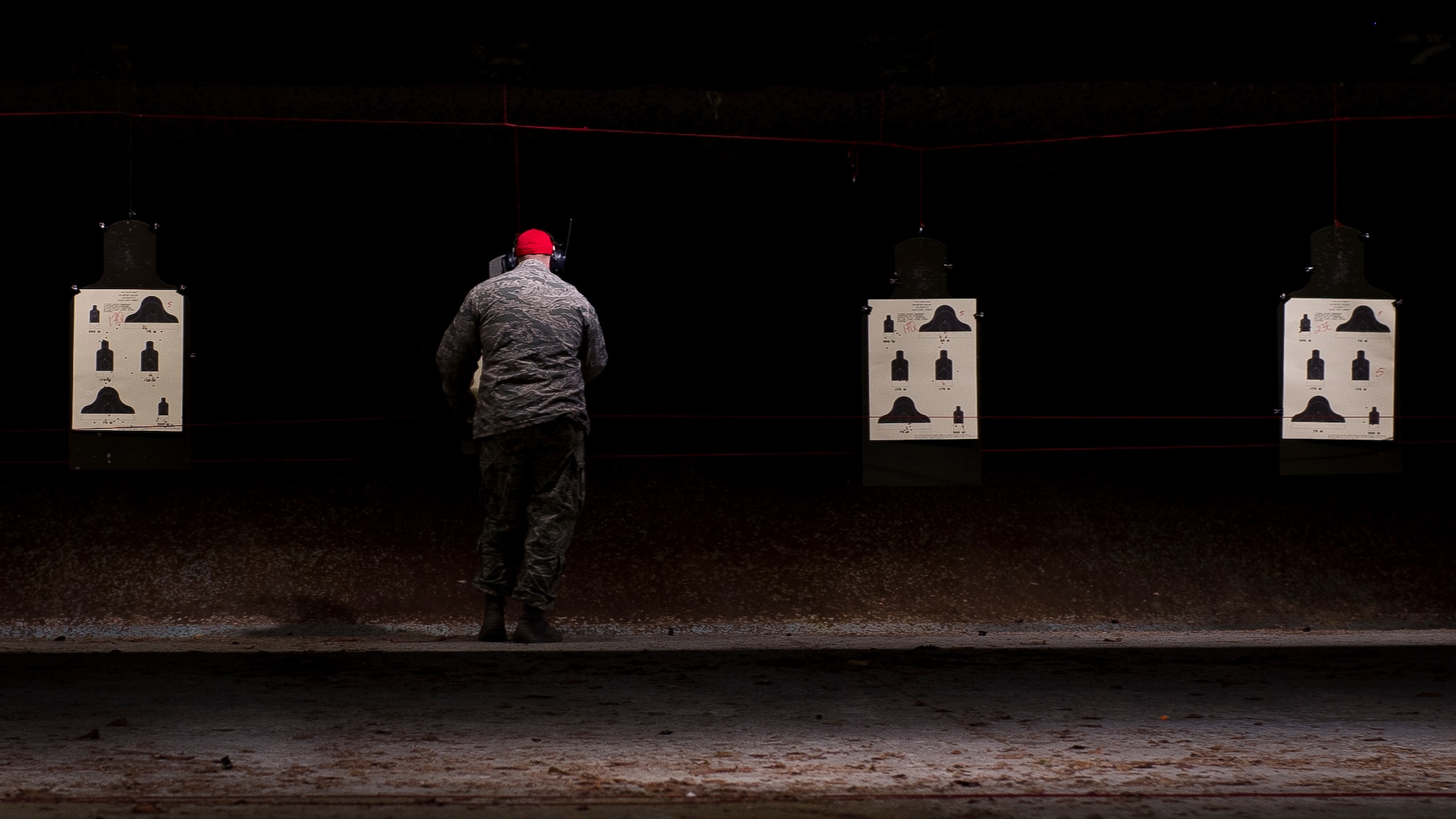 JOINT BASE CHARLESTON, S.C. – A 628th Security Forces Squadron Combat Arms Training and Maintenance instructor, tallies up the number of bullets that hit the targets during an M-4 carbine qualifying session at night at the CATM firing range, Feb. 11, 2015, on Joint Base Charleston Air Base, S.C. Airmen fire more than 200 rounds during the course and are required to accomplish this course annually. (U.S. Air Force photo/ Senior Airman Dennis Sloan)