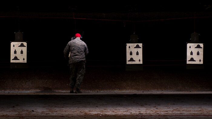 JOINT BASE CHARLESTON, S.C. – A 628th Security Forces Squadron Combat Arms Training and Maintenance instructor, tallies up the number of bullets that hit the targets during an M-4 carbine qualifying session at night at the CATM firing range, Feb. 11, 2015, on Joint Base Charleston Air Base, S.C. Airmen fire more than 200 rounds during the course and are required to accomplish this course annually. (U.S. Air Force photo/ Senior Airman Dennis Sloan)