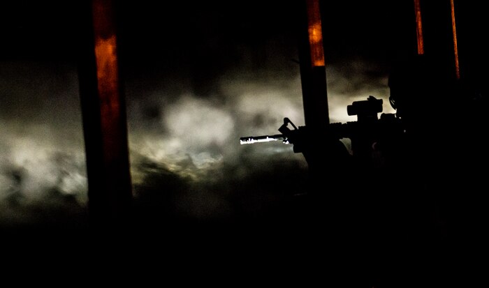 JOINT BASE CHARLESTON, S.C. – A 628th Security Forces Squadron patrolman fires downrange with only the light from his flashlight to illuminate the target during an M-4 carbine qualifying session at night at the Combat Arms Training and Maintenance firing range, Feb. 11, 2015, on Joint Base Charleston, S.C. Aside from testing Airmen’s ability to fire an M-4 carbine from several positions--prone, standing and wearing a gas mask--they are also tested in lowlight situations as well as pitch blackness, wearing Night Vision Goggles to see. (U.S. Air Force photo/ Senior Airman Dennis Sloan)