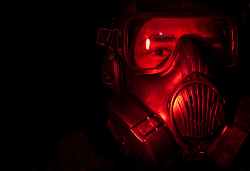 JOINT BASE CHARLESTON, S.C. – Staff Sgt. Norman Allen, 628th Security Forces Squadron patrolman, wears a gas mask during M-4 carbine qualifying at night at the Combat Arms Training and Maintenance firing range, Feb. 11, 2015, on Joint Base Charleston, S.C. The qualifying course tests Airmen’s ability to fire an M-4 carbine from several positions: prone, standing and wearing a gas mask. (U.S. Air Force photo/ Senior Airman Dennis Sloan)