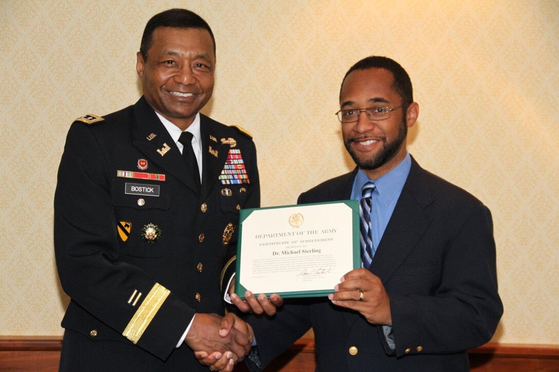 Lt. Gen. Thomas P. Bostick, Commanding General of the U.S. Army Corps of Engineers,  presents a certificate of achievement to Dr. Michael Sterling for his selection as Black Engineer of the Year for Professional Achievement (Government Category).