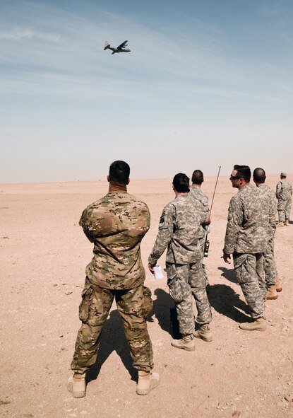 SOUTHWEST ASIA - Airmen from the 82nd Expeditionary Air Support Operations Squadron watch a C-130 approach during drop zone control officer training Feb. 10, 2015. The C-130 is from the 737th Expeditionary Airlift Squadron here and helped 82nd EASOS Airmen practice calling in aircraft for resupply drops. (U.S. Air Force photo by Tech. Sgt. Jared Marquis/released)