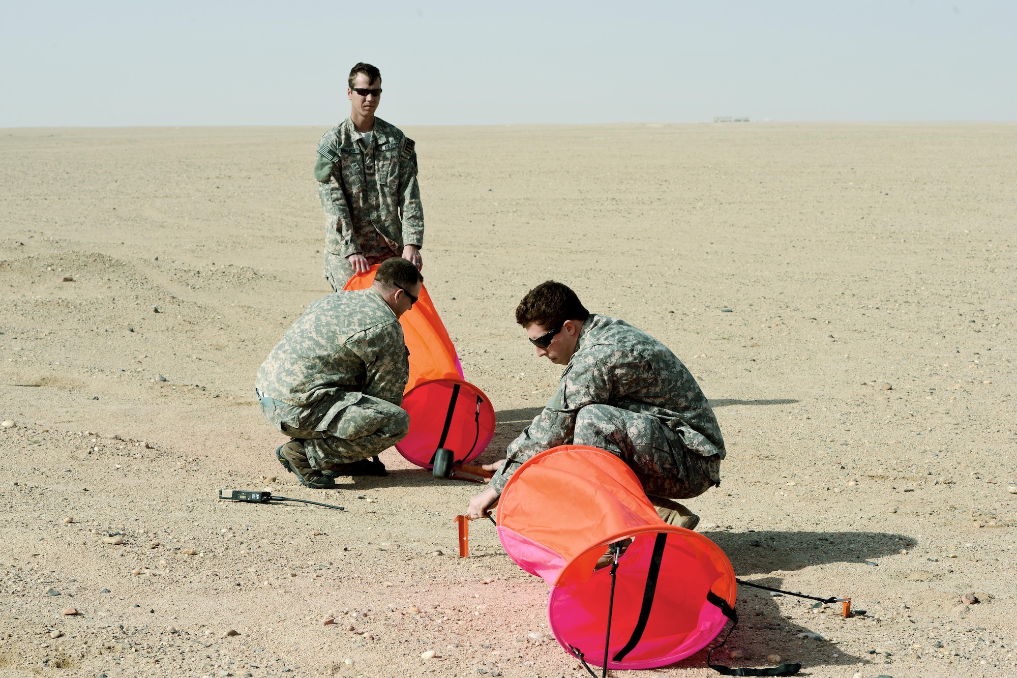 SOUTHWEST ASIA - Airmen from the 82nd Expeditionary Air Support Operations Squadron build a target during drop zone control officer training Feb. 10, 2015. The 737th Expeditionary Airlift Squadron here helped the 82nd EASOS Airmen practice calling in aircraft for resupply drops. (U.S. Air Force photo by Tech. Sgt. Jared Marquis/released)
