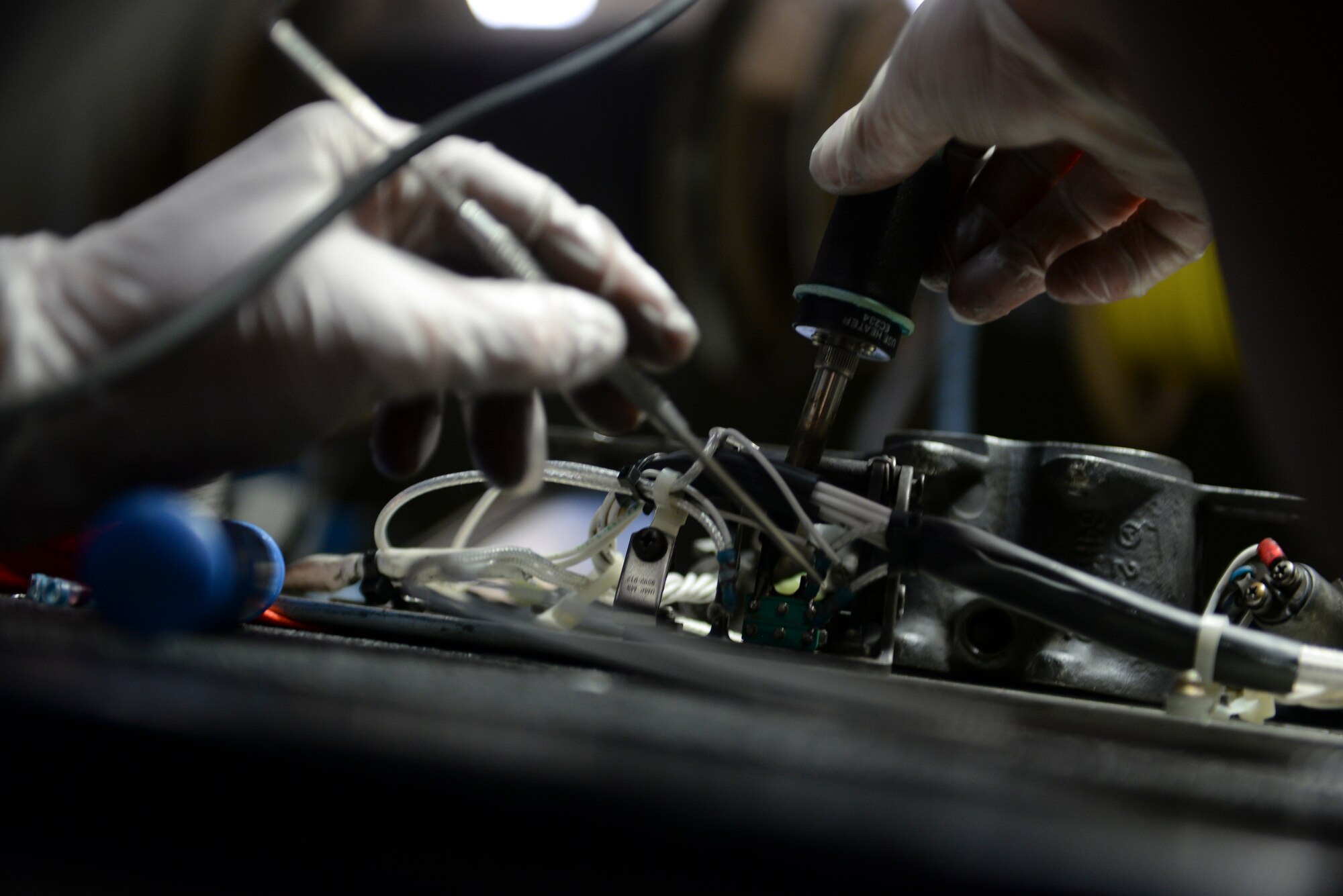 Senior Airman Robert Eby, 51st Munitions Squadron A-10 armament systems journeyman, removes solder from a bad firing contact on a bomb rack micro switch Feb. 10, 2015, at Osan Air Base, Republic of Korea. A-10s are inspected on their 30-mm gun, feed and handling system, ammunition loading adaptor and triple ejector rack. (U.S. Air Force photo by Senior Airman David Owsianka)