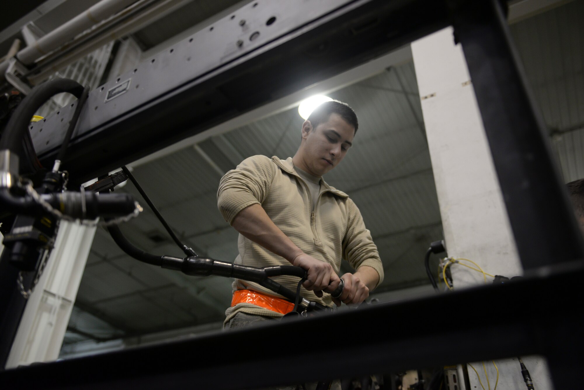 Airman 1st Class Bryan Roberts, 51st Munitions Squadron F-16 armament systems technician, connects a store system tester connector to an F-16 missile launcher for an electrical check Feb. 10, 2015, at Osan Air Base, Republic of Korea. F-16s are inspected for their 20-mm gun, air-to-air missiles, conventional air-to-air and air-to-surface munitions and electronic countermeasure pods. (U.S. Air Force photo by Senior Airman David Owsianka)