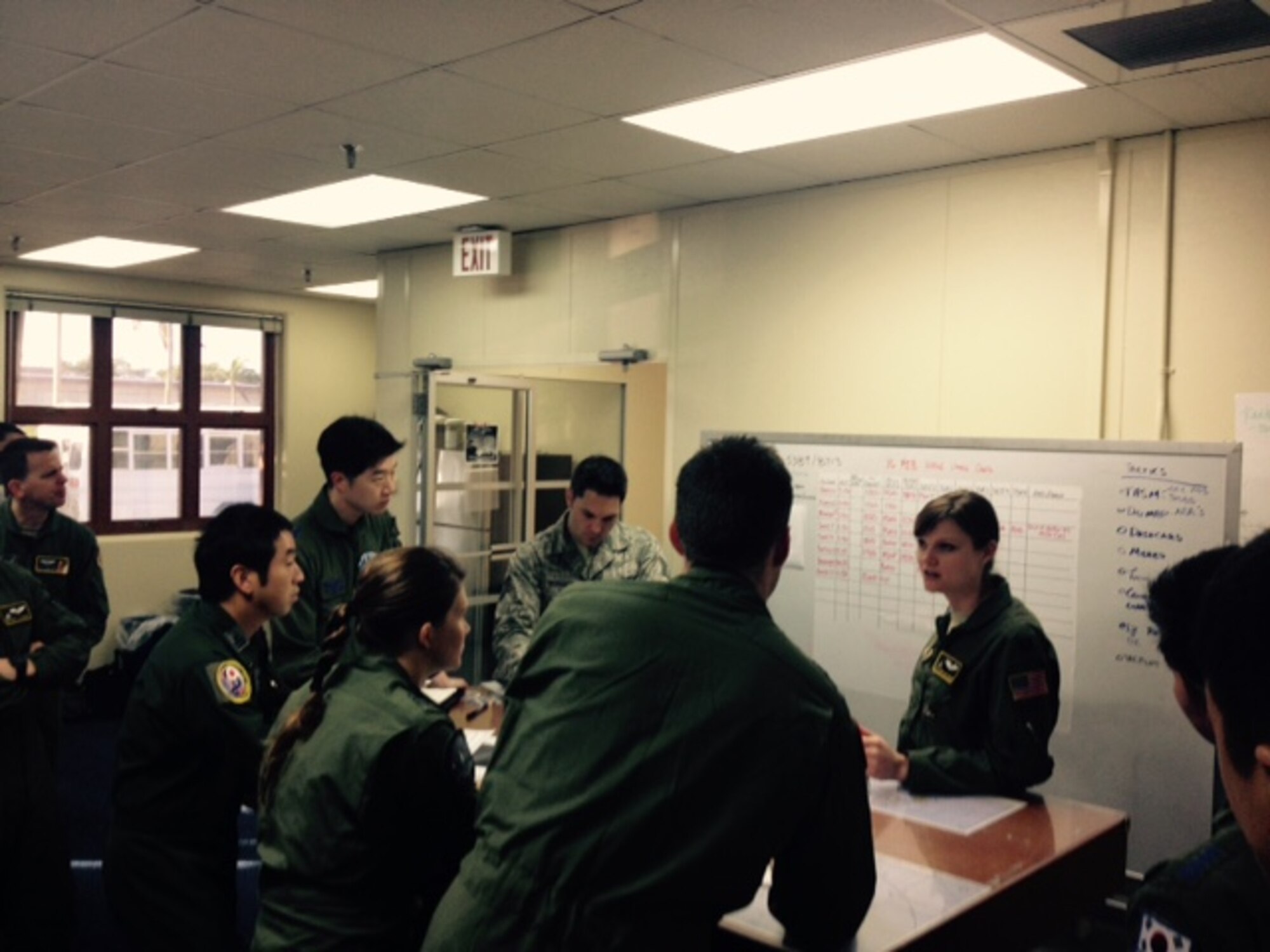 Capt. Allison Ohlinger, a C-130H navigator assigned to the 36th Airlift
Squadron and lead U.S. COPE NORTH 2015 HA/DR planner, conducts a daily
schedule review with her Republic of Korea, Royal
Australian Air Force, and Japanese Air Self-Defense Force counterparts.  The
daily schedule review is part of a plan-execute concept conceived and agreed
upon by all partner forces in order to effectively conduct combined HA/DR
operations in support of Exercise COPE NORTH 15 interoperability objectives.