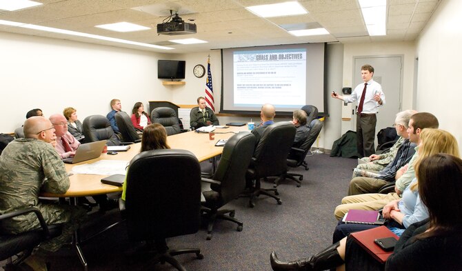 Aaron Briggs, HB&A lead planner, standing right, briefs Lt. Col. Scott Bryant, 436th Civil Engineer Squadron commander, seated left, on future development options for four of 13 area development plan areas Jan. 23, 2015, at Dover Air Force Base, Del. Stakeholders within each of the four ADP areas provided user and facility input to HB&A team members in order to establish Dover AFB's Installation Development Plan.  (U.S. Air Force photo by Roland Balik)