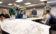 Aaron Briggs, HB&A lead planner, standing right, listens to input from Team Dover members affected by the Area Development Plan Jan. 20, 2015, at Dover Air Force Base, Del. Briggs and HB&A team members met with stakeholders located in four ADP areas to discuss their functions within each area.  (U.S. Air Force photo by Roland Balik)