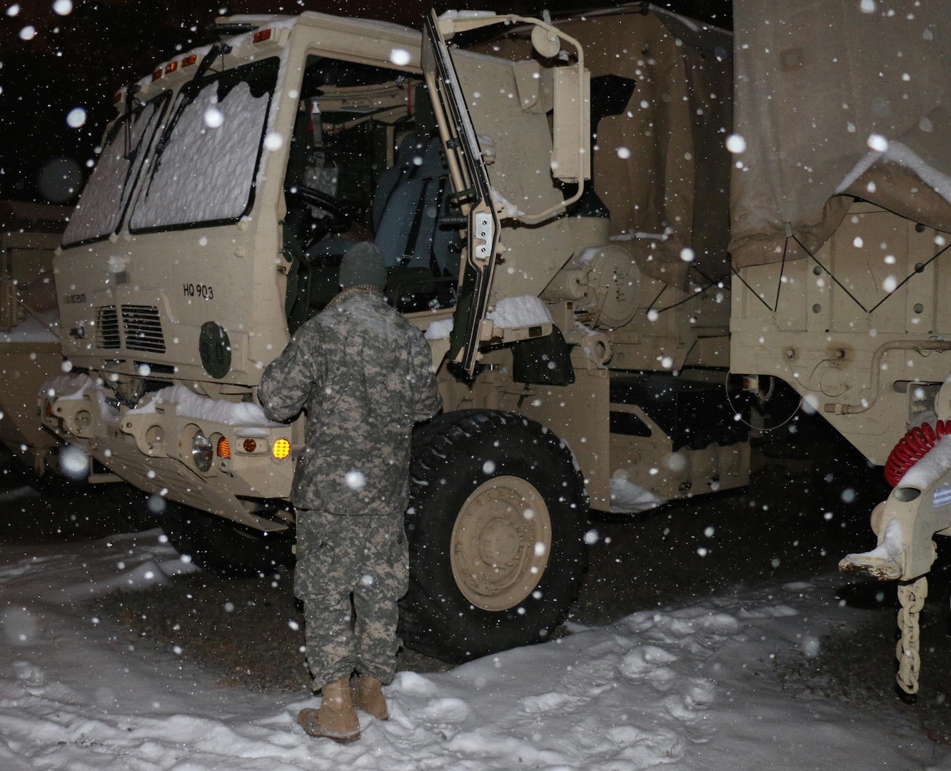 Staff Sgt. Alexander Yeniscavich, Virginia National Guard Soldier assigned to the Fredericksburg-based Headquarters Company, 116th Brigade Special Troops Battalion, 116th Infantry Regiment, 116th Infantry Brigade Combat Team, prepares a Humvee for possible winter storm operations Feb. 16, 2014, in Fredericksburg, Va.