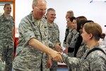 Air Force Gen. Craig McKinley, chief of the National Guard Bureau, and Army Maj. Gen. David Sprynczynatyk, the adjutant general of North Dakota, greet Soldiers at Camp Bondsteel's dining facility in Kosovo May 23, 2010.